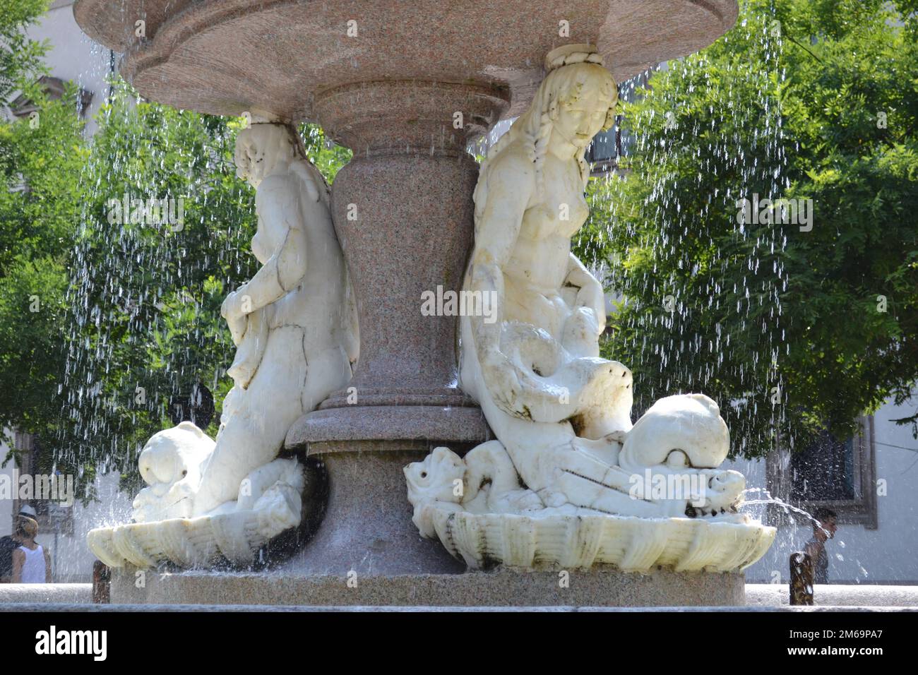 Close-up view of the beautiful fountain of the three sirens in white marble in Milan on a sunny summer day. Detail of two marble mermaids. Stock Photo