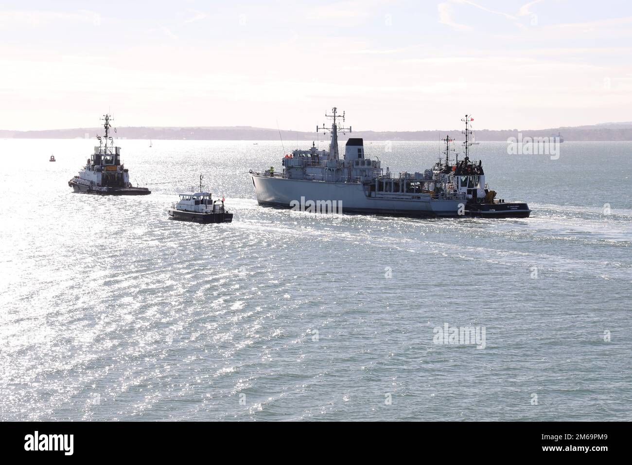 The tug FORTITUDE tows the ex-Royal Navy minehunter ATHERSTONE out of harbour and into the Solent Stock Photo