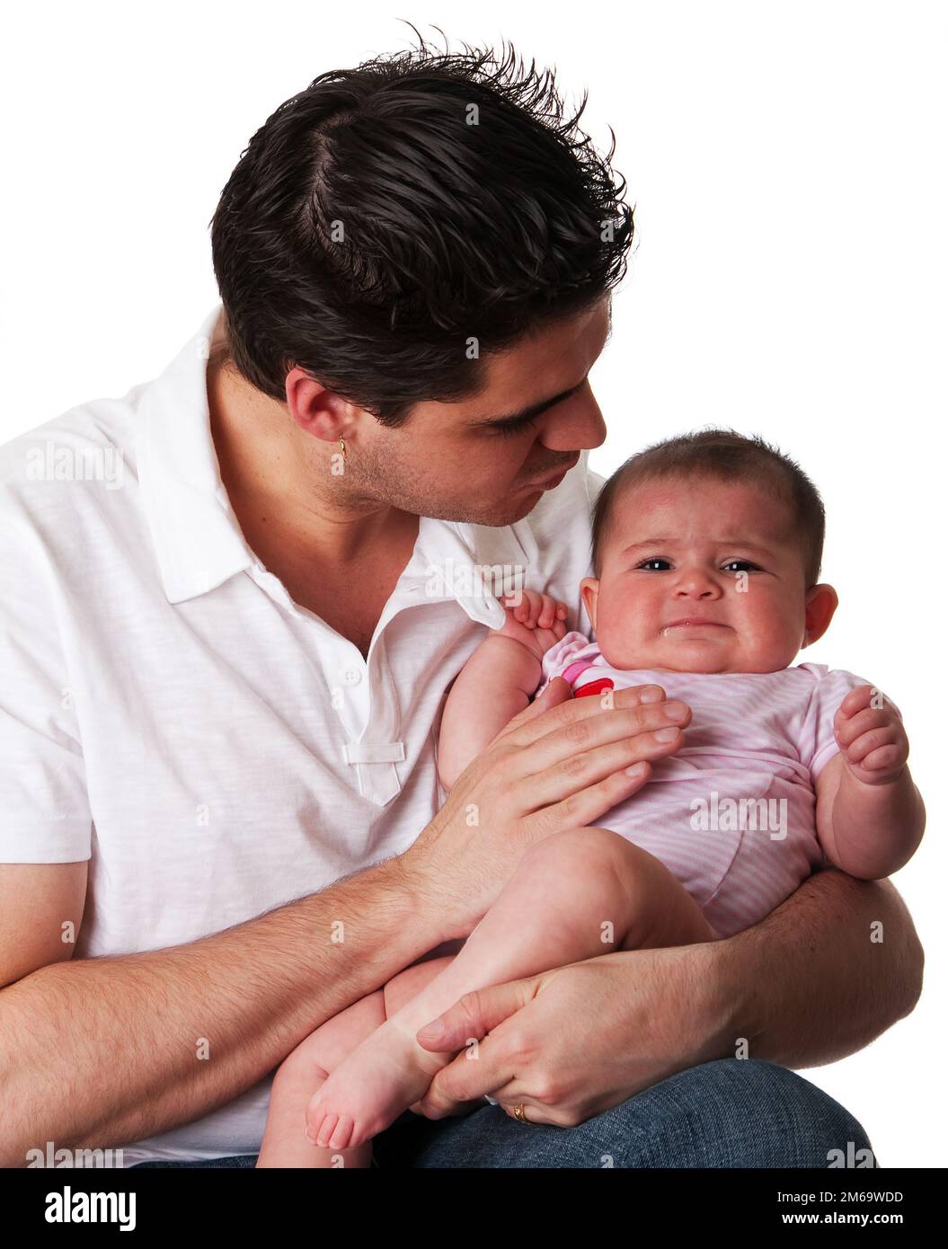 Father calming unhappy baby daughter Stock Photo