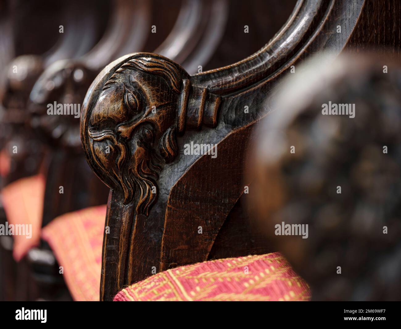 Carved faces on the armrests of the thirteenth century Early English choir stalls in Hexham Abbey, Northumberland, England Stock Photo