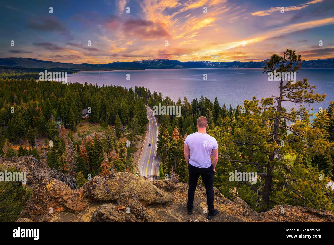 Hiker enjoying sunset over Lake Tahoe from the Eagle Rock in California Stock Photo