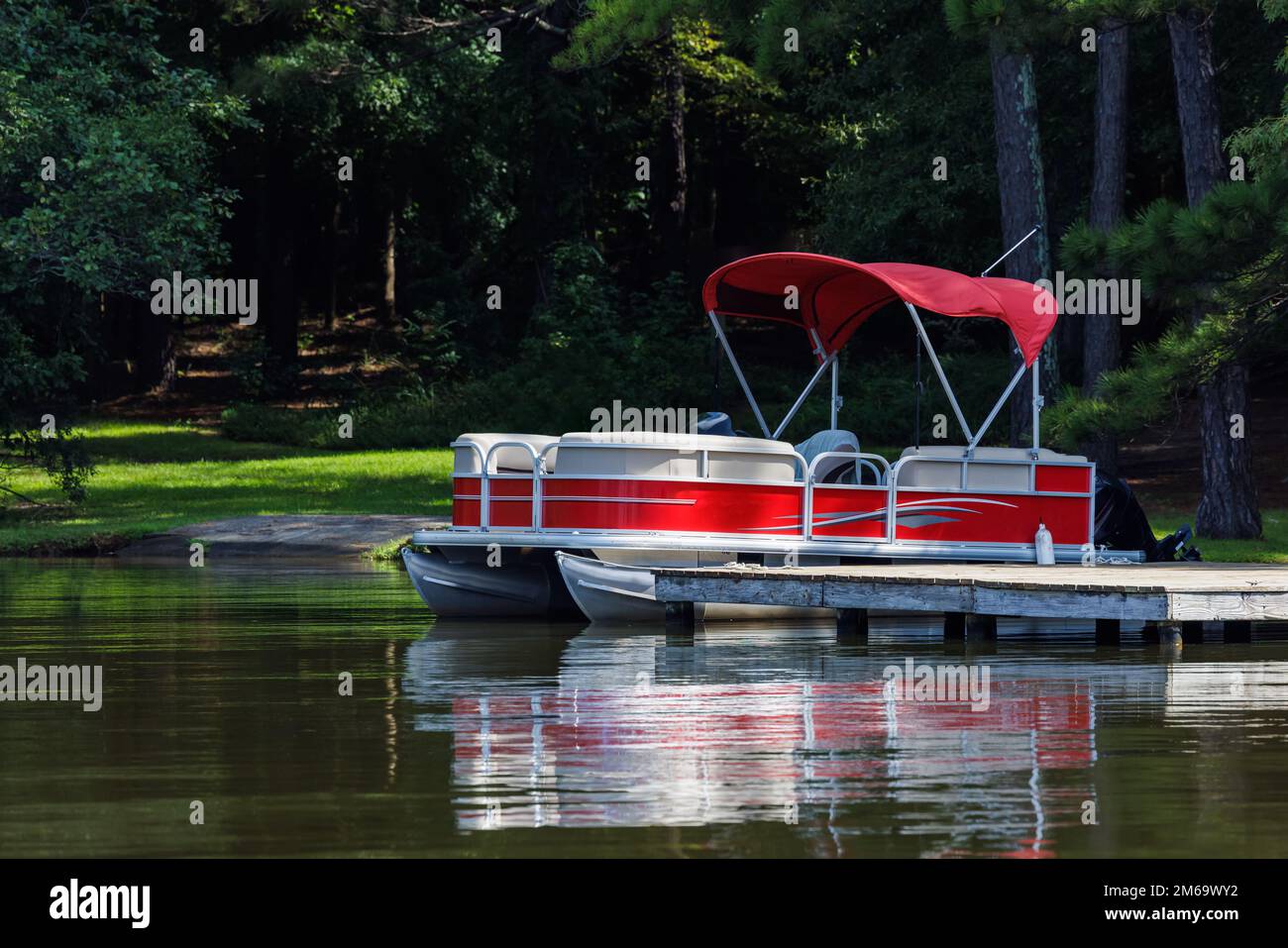 Pontoon boat at private dock on lake Stock Photo Alamy