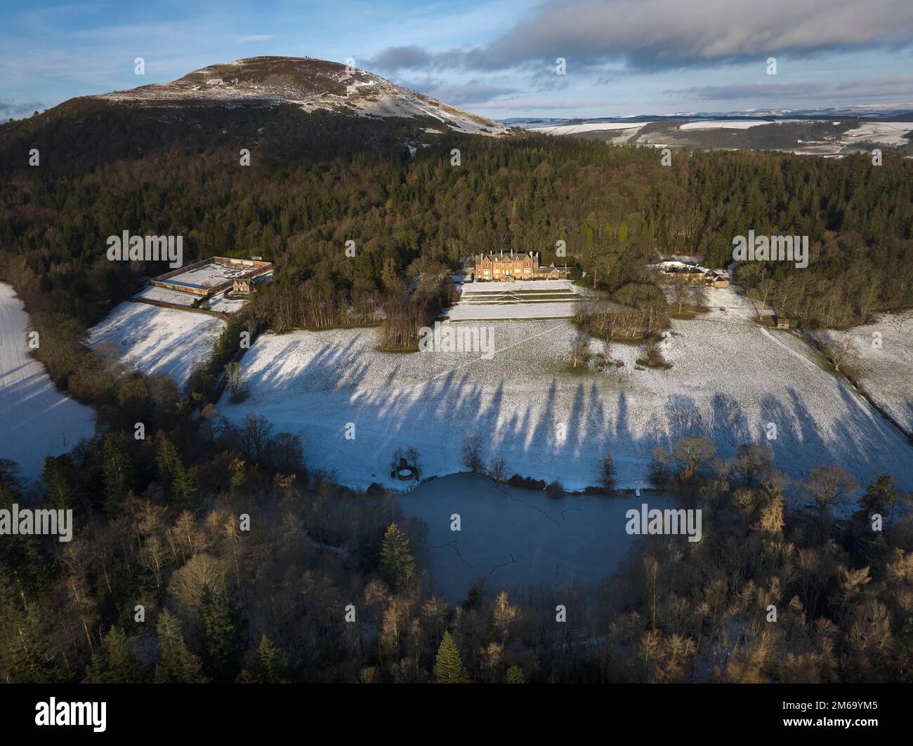 Aerial view of Eildon Hall residence of the Earl of Dalkeith nestling on the south side of The Eildon Hills on a crisp December day. Stock Photo