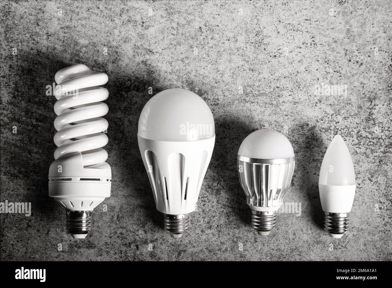 Top view of 4 different e27 household light bulbs on a gray background Stock Photo