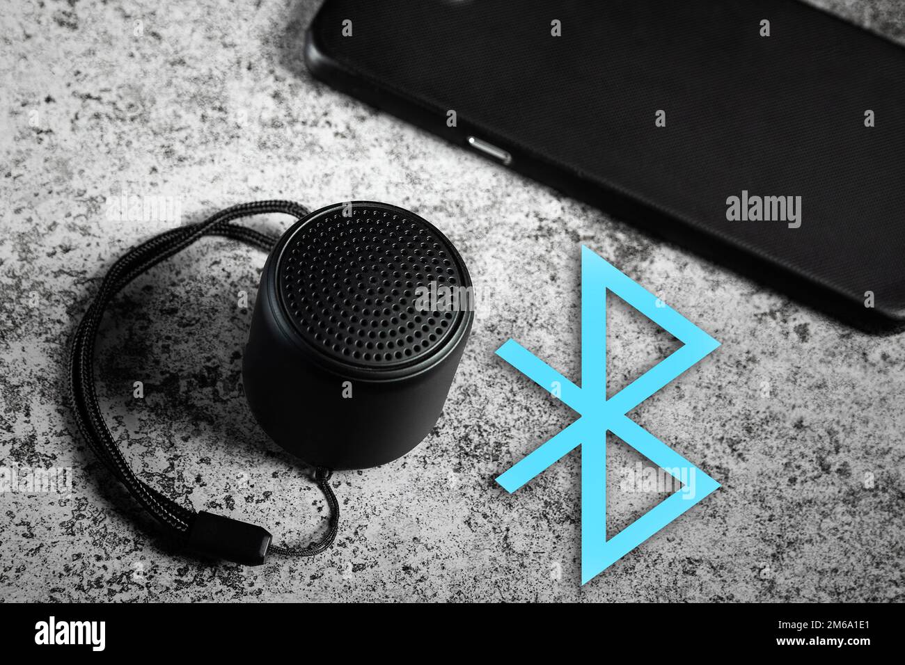 Black mini Bluetooth speaker and smartphone conected with Bluetooth Stock Photo
