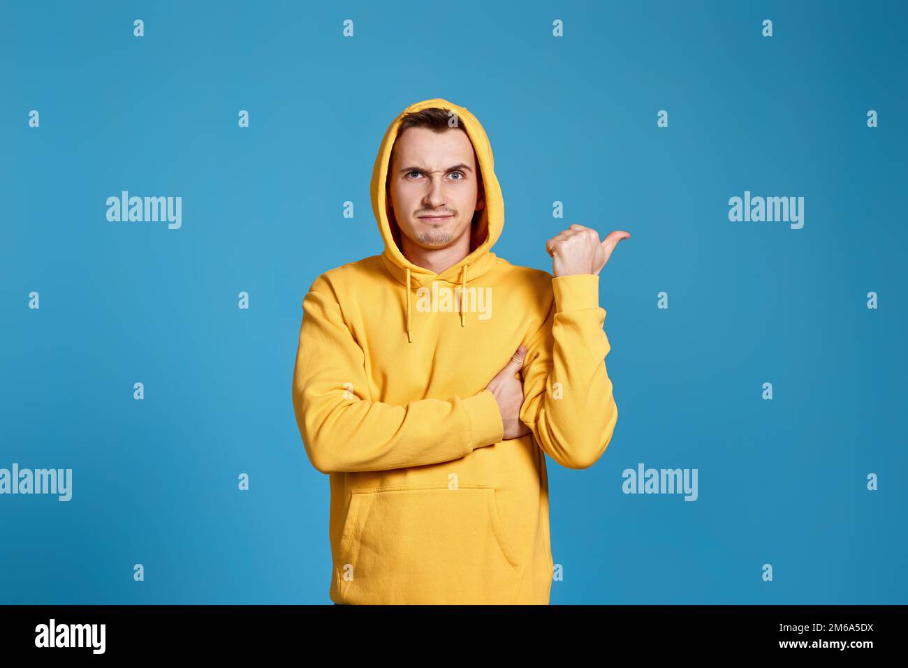 Cheerful handsome man pointing at copy space Stock Photo