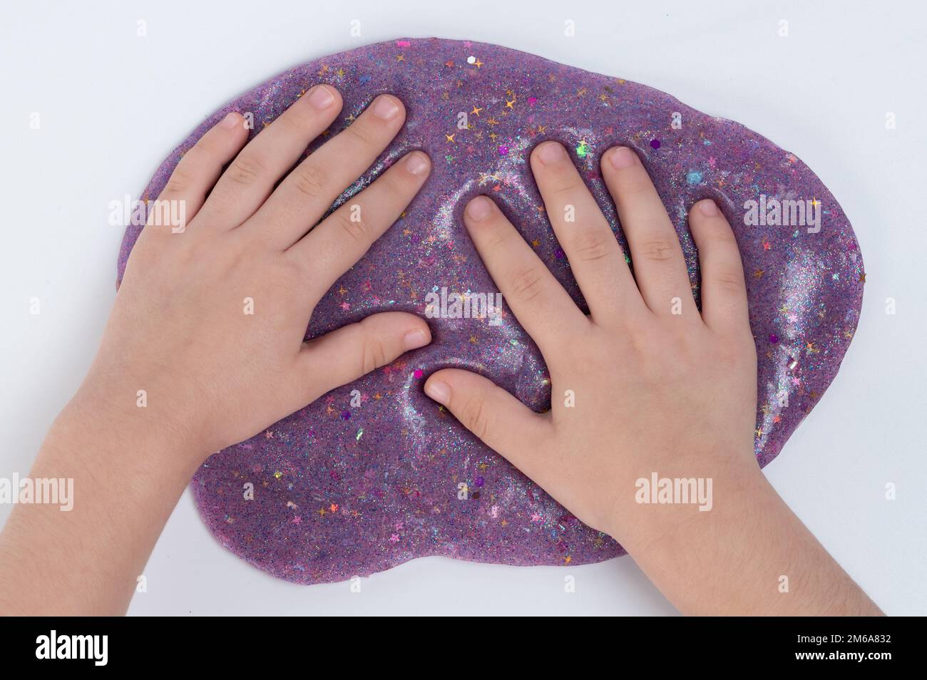 Child handson purple color slime  abovetop view isolated Stock Photo