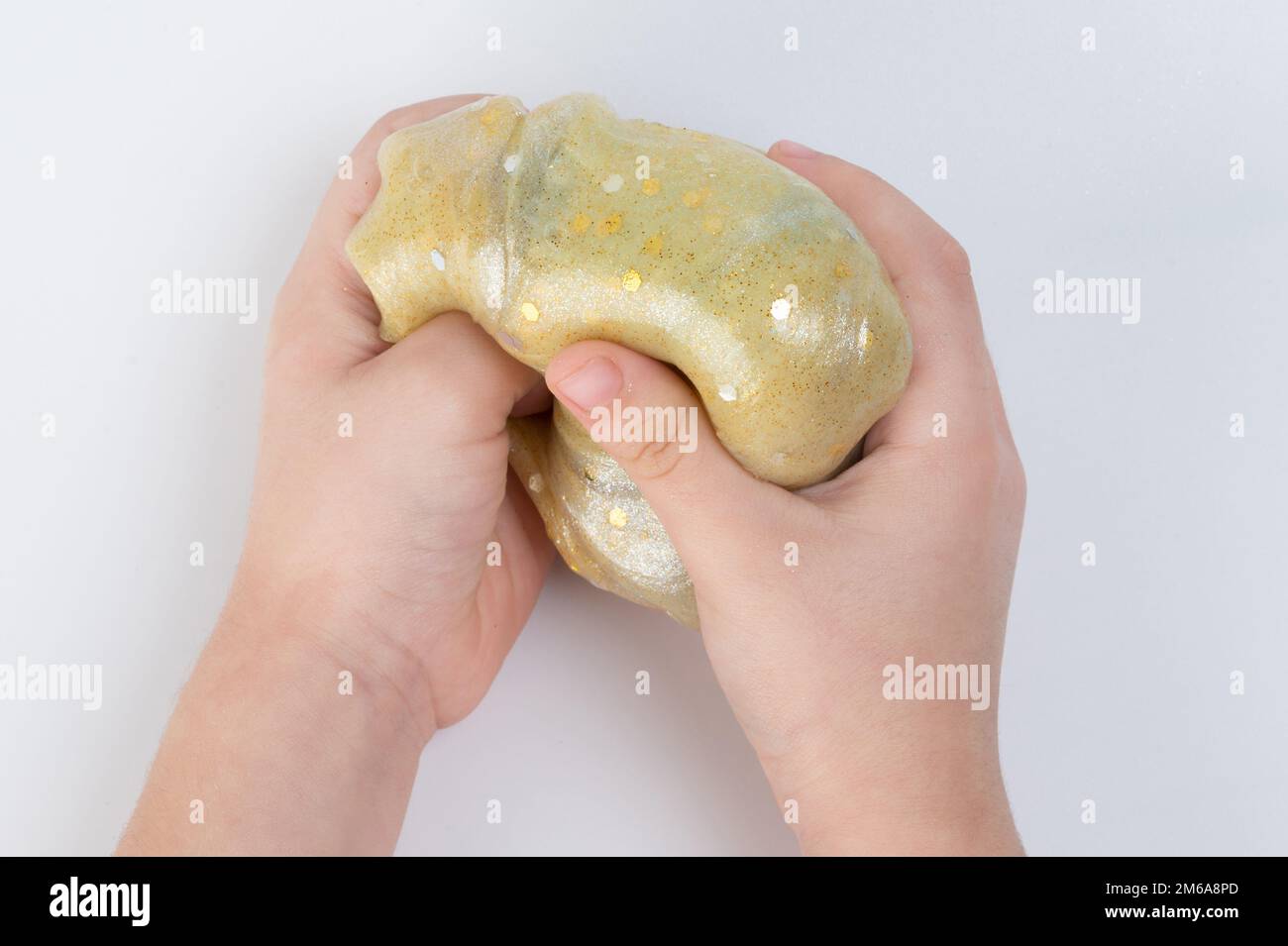Child playwith colorful slime close up view isolated Stock Photo