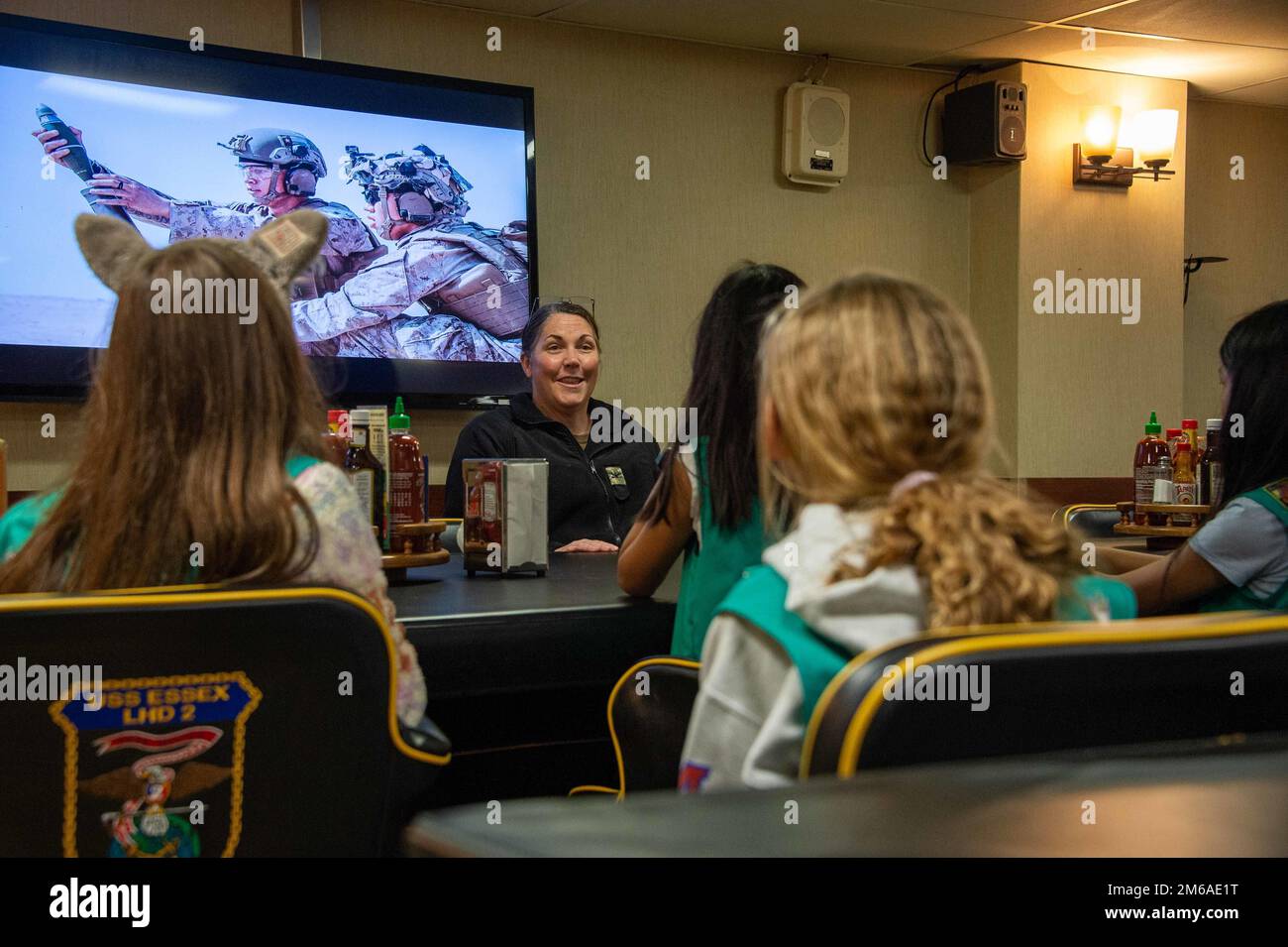 SAN DIEGO (April 20, 2022) Capt. Kelly Fletcher, commanding officer of amphibious assault ship USS Essex (LHD 2), a native of West Hempstead, New York, center, speaks with visitors from San Diego Girl Scouts during a ship tour, April 20, 2022. Essex is homeported in San Diego. Stock Photo