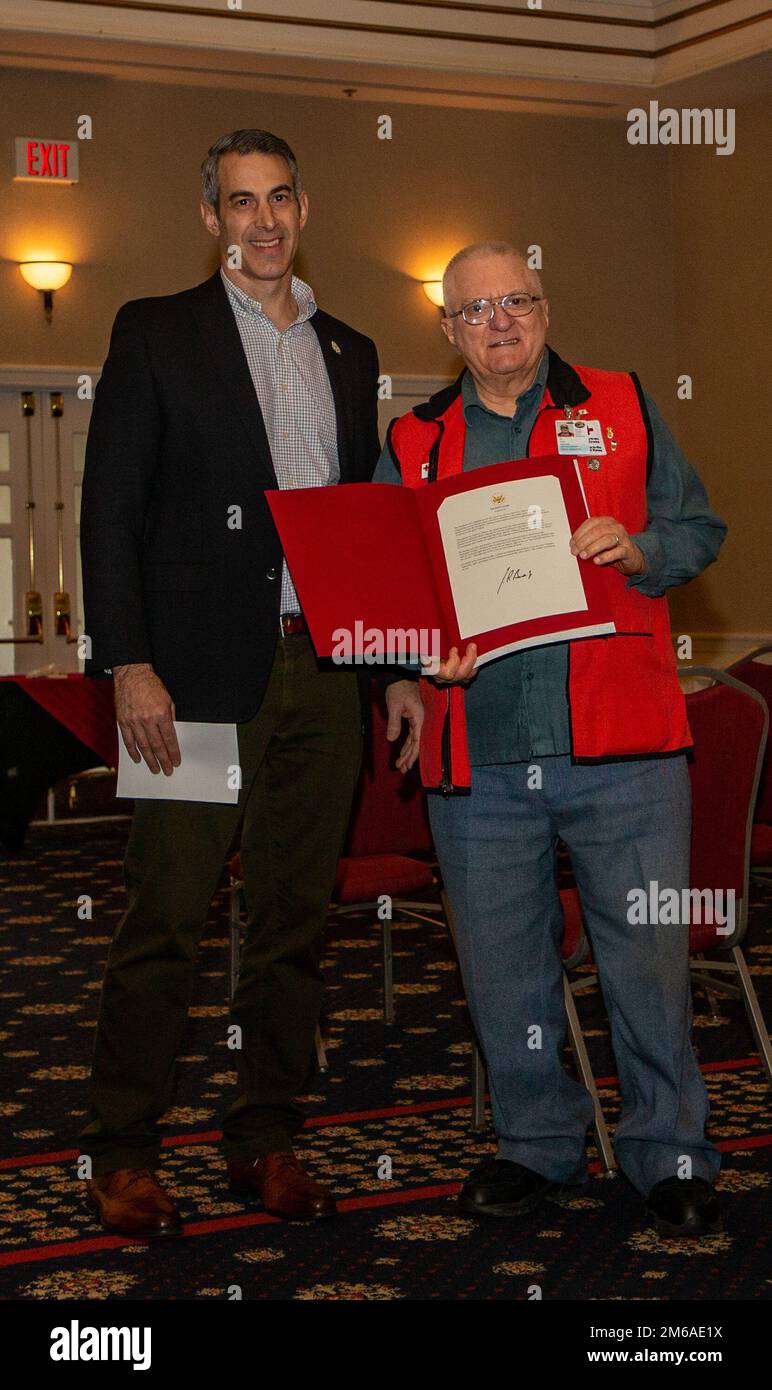 Chris Duffley, the regional director of Service to Armed Forces of the National Capital and Greater Chesapeake Region for the American Red Cross, awards Doug Whitwood, with the Lifetime Achievement Award, Presidential Volunteer Service Award (PVSA) at the Volunteer Appreciation Awards ceremony hosted at The Clubs at Quantico on Marine Corps Base Quantico, Virginia, April 21, 2022. The Lifetime Achievement Award, PVSA is awarded to individuals with at least 4,000 volunteer hours, which Whitwood had 4,100 hours with the American Red Cross. Stock Photo