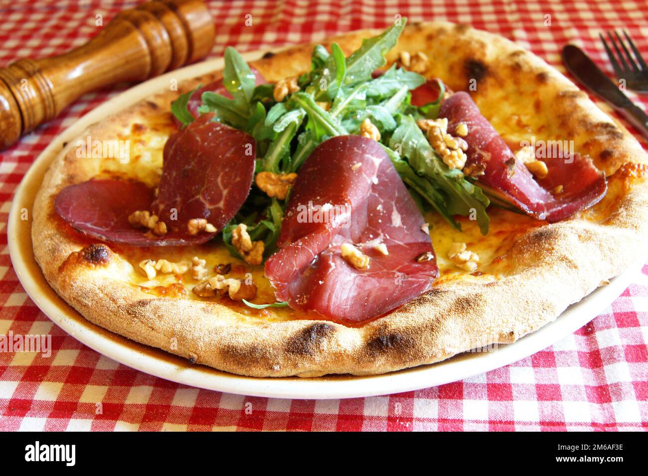 Serrano ham pizza. Neapolitan pizza made with baked vegetables and serrano ham. Italian