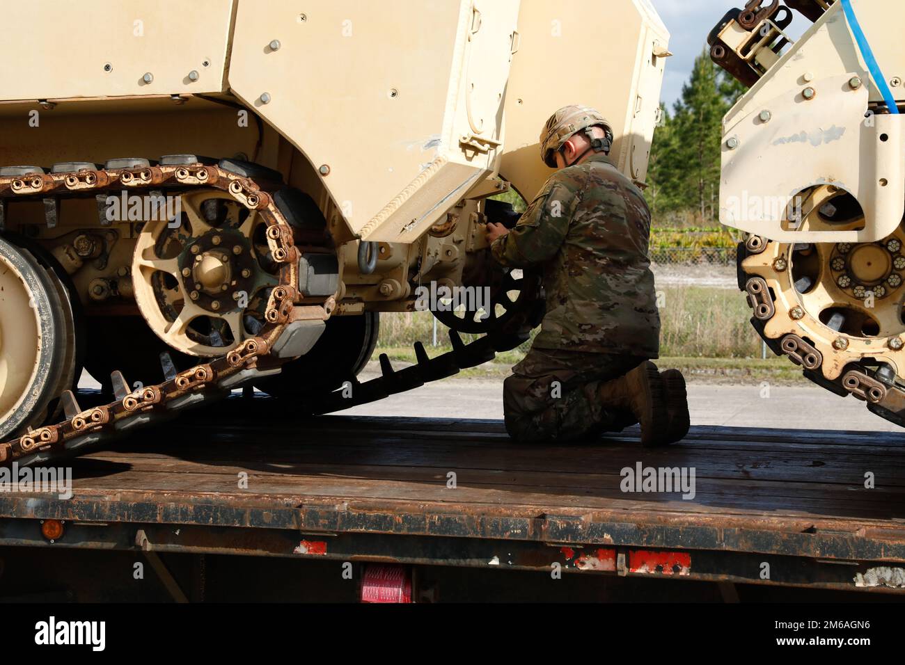 A U.S. Army Soldier assigned to the 3rd Infantry Division installs a hook onto an M113 Armored Personnel Carrier in preparation for tying it down to a truck trailer at Fort Stewart, Georgia, April 21. 2022. The 3rd ID divested the armored vehicles to support the Presidential Response requirements for the European Theater of Operations for the purpose of providing immediate military assistance to Ukraine. Stock Photo