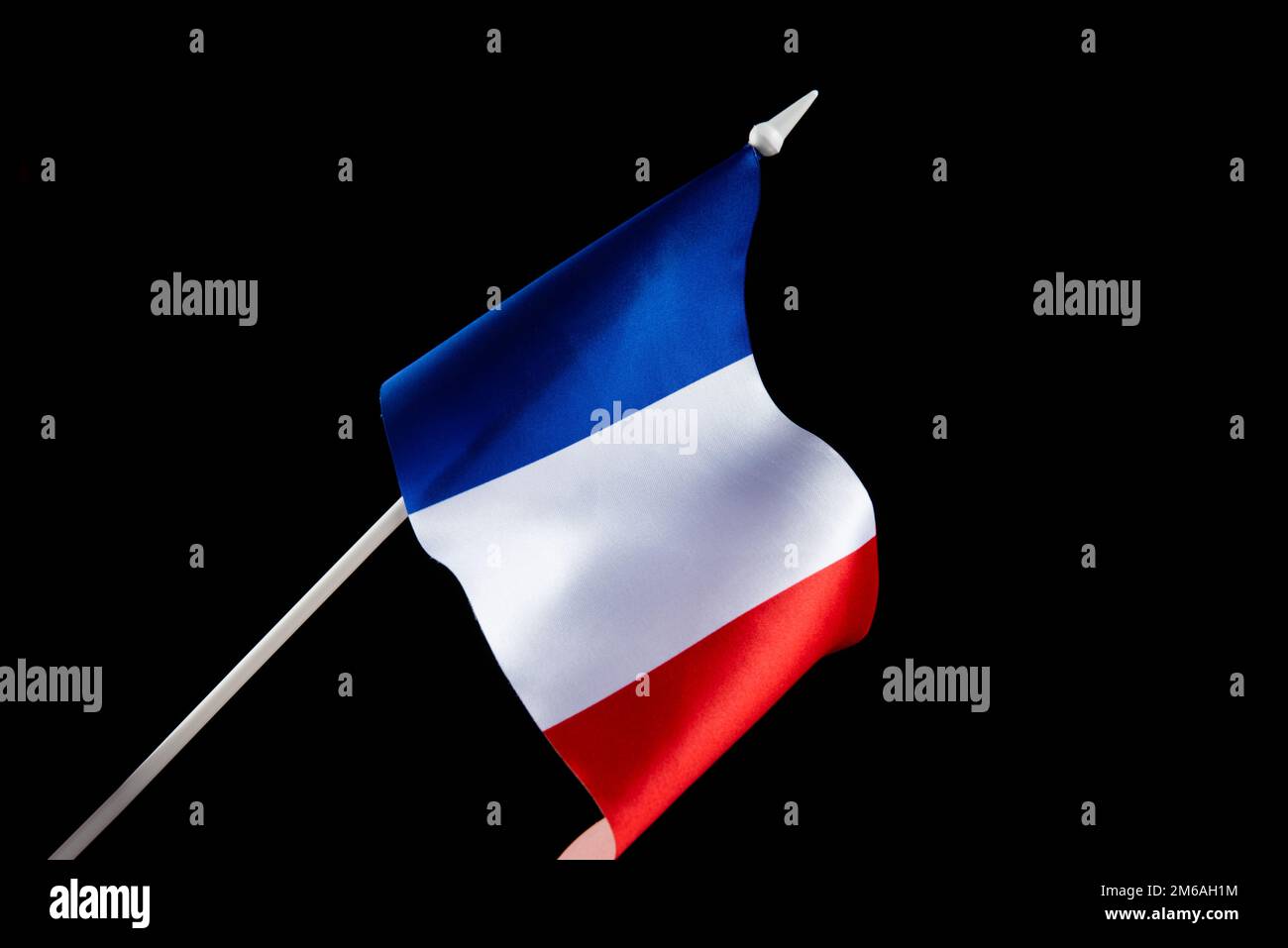 The flag of France on a black background developing flying in the wind Stock Photo