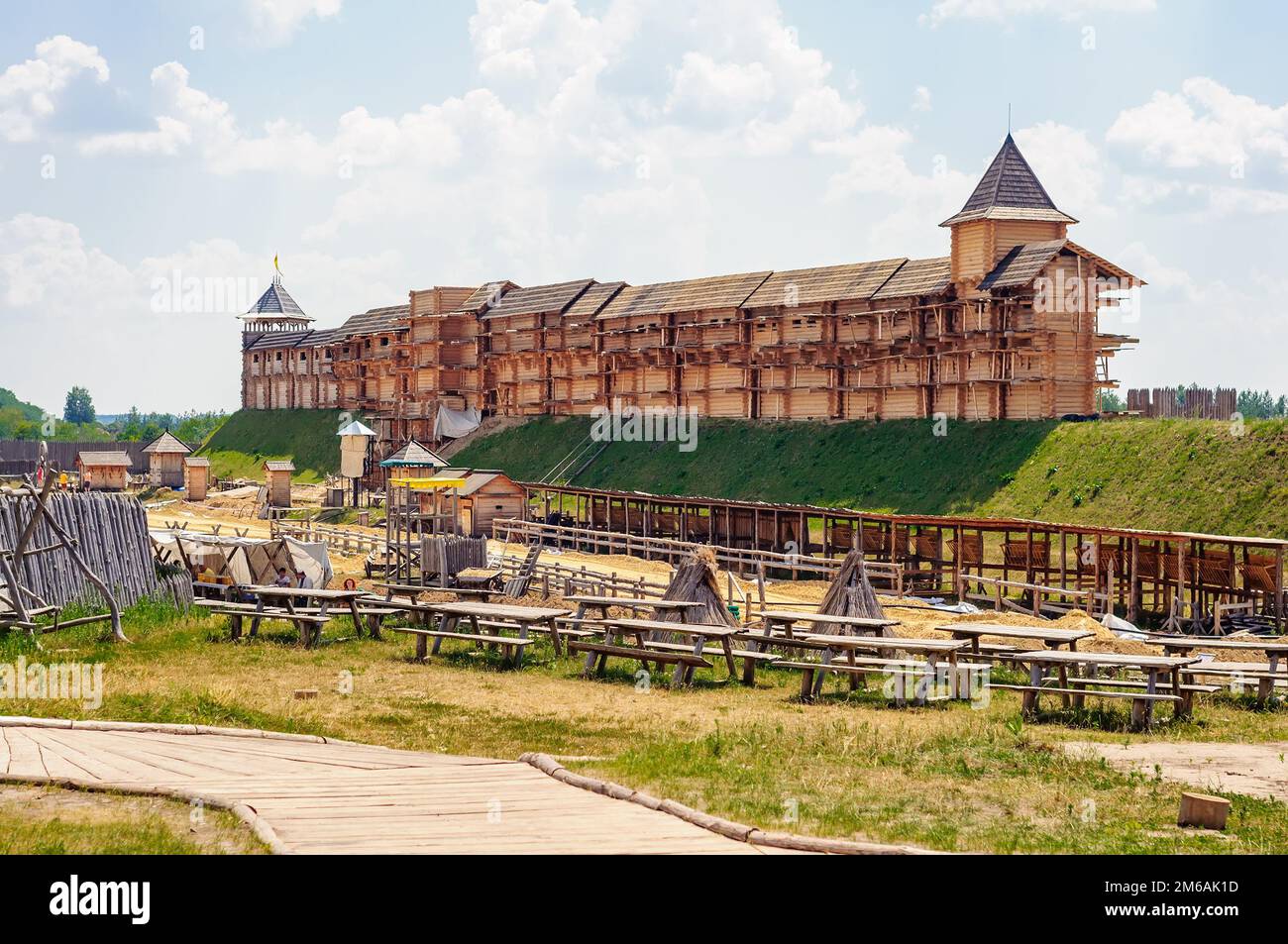 Park Kievan Rus, Kyiv region, Ukraine. July 06, 2013. Wooden fortifications with towers on the earthen rampart. Medieval reconstruction. Stock Photo
