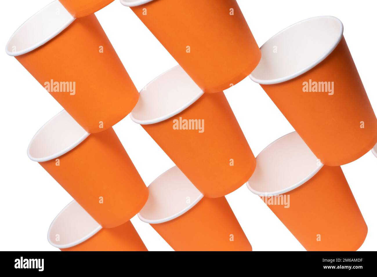 Pyramid of orange disposable paper cups isolated on white background ...