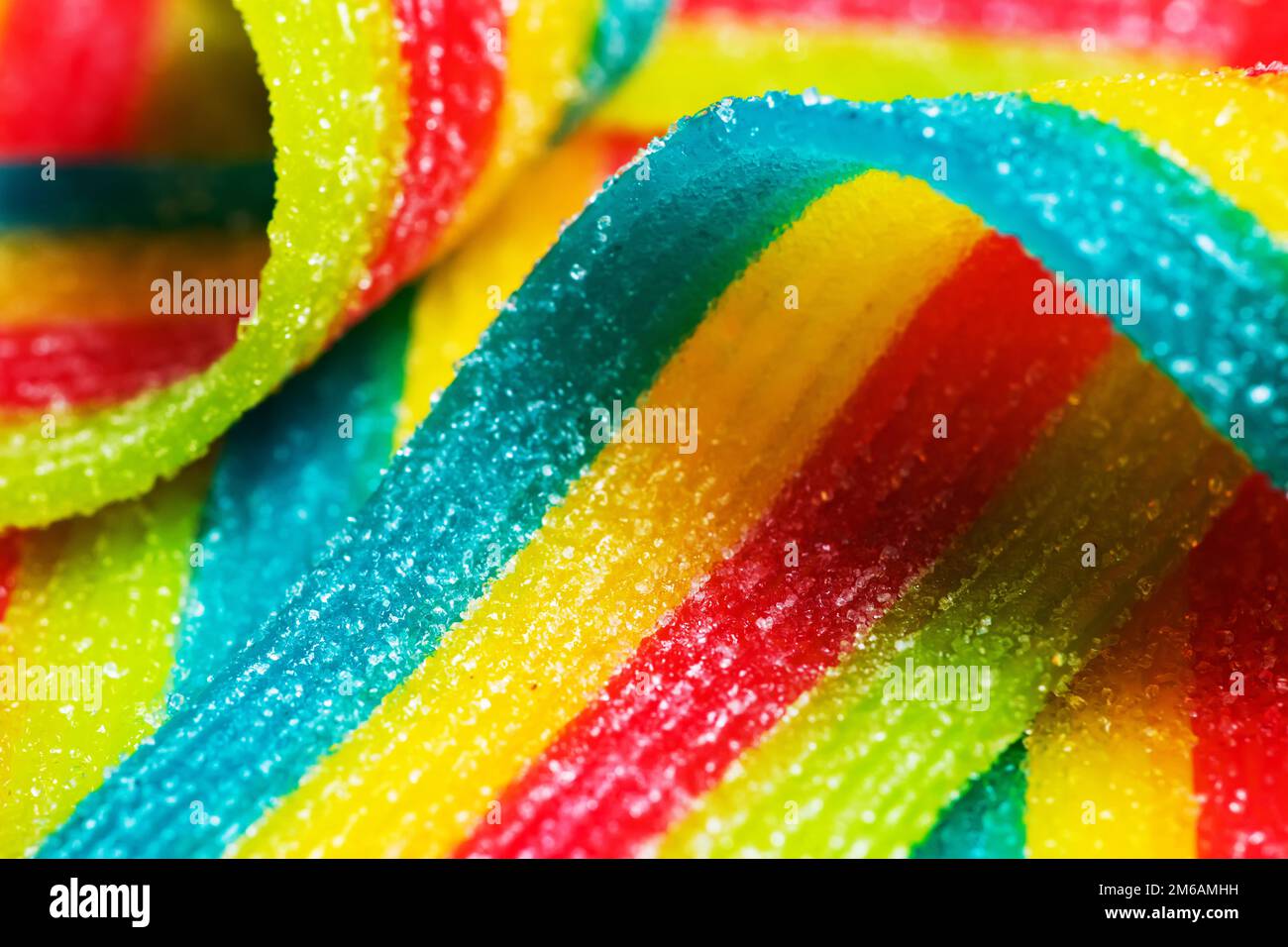 Colorful jelly candies strips in sugar sprinkles. Sour flavored rainbow  candy background Stock Photo by esindeniz