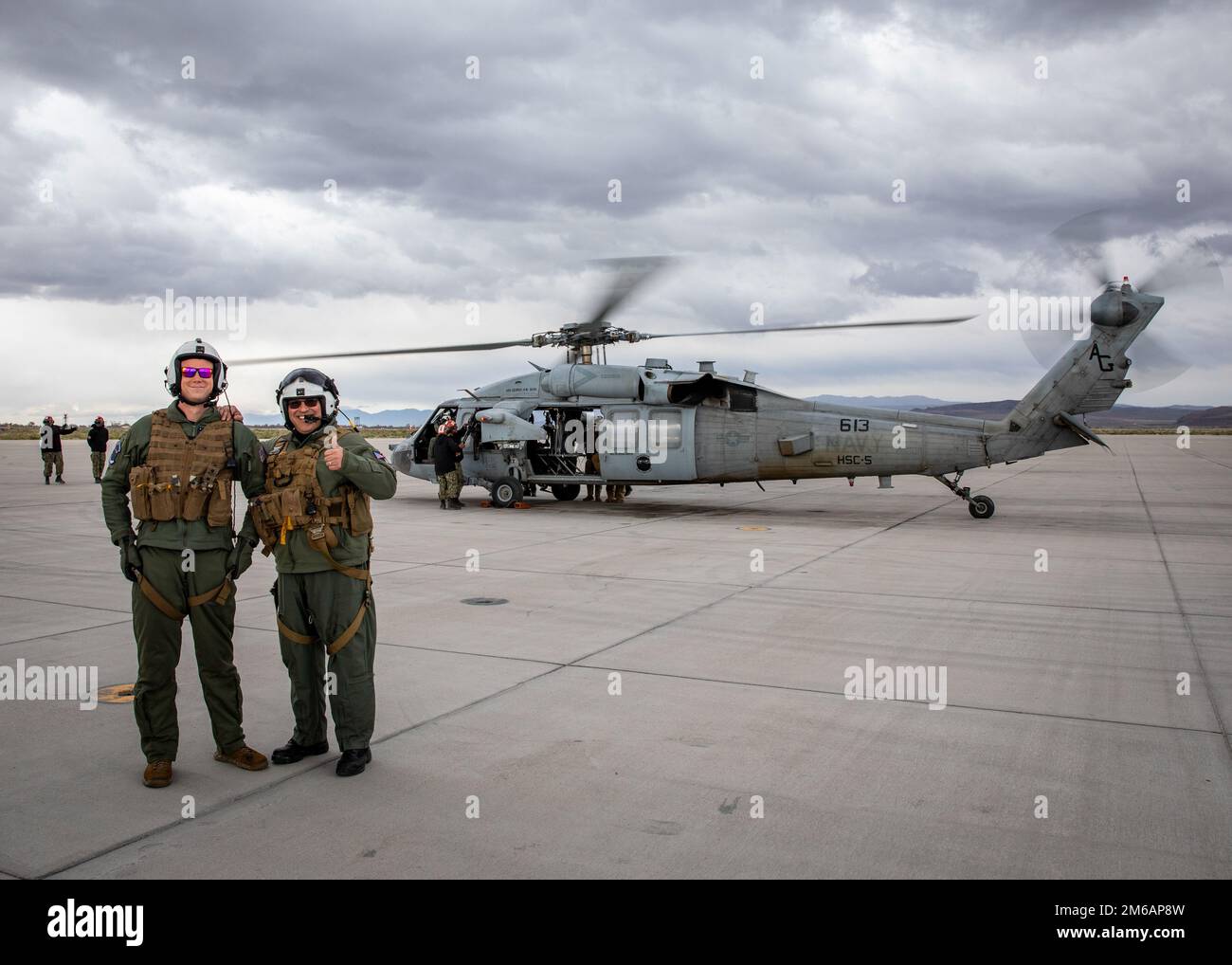 Rear Adm. Dennis Velez, commander of Carrier Strike Group (CSG) 10, left, and Naval Aircrewman Helicopter 2nd Class Brian Sadin, assigned to Helicopter Sea combat Squadron (HSC) 5, pose for a photo in front of an MH-60 Seahawk at Naval Air Station Fallon. Carrier Air Wing (CVW) 7 is the offensive air and strike component of Carrier Strike Group (CSG) 10 and the George H.W. Bush CSG. The squadrons of CVW-7 and Strike Fighter Squadron (VFA) 143, VFA-103, VFA-86, VFA-136, Electronic Attack Squadron (VAQ) 140, Carrier Airborne Early Warning Squadron (VAW) 121, Helicopter Sea Combat Squadron (HSC) Stock Photo