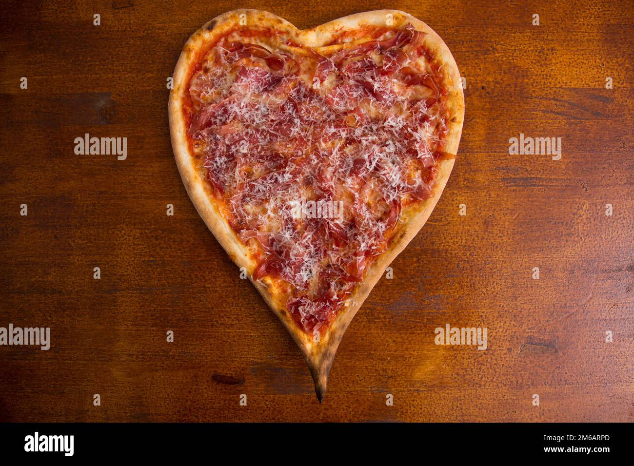 Heart-shaped Iberian ham pizza. Neapolitan pizza with Italian Recipe