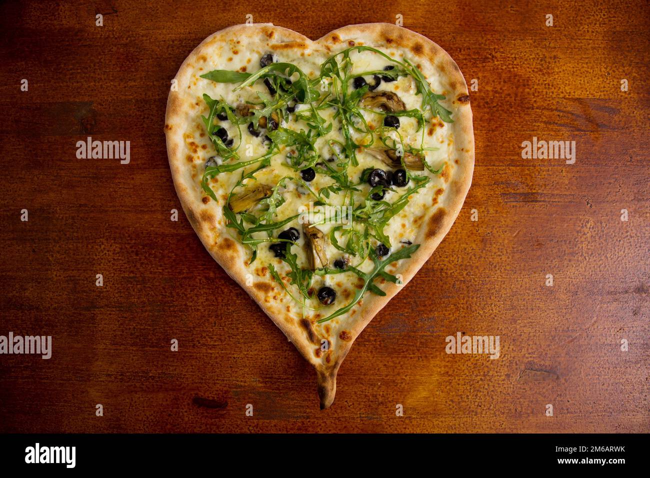 Heart-shaped Iberian ham pizza. Neapolitan pizza with Italian Recipe