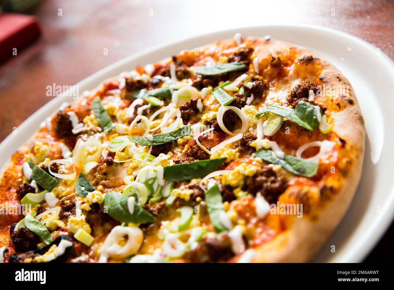 Pizza with meat and curry. Neapolitan pizza made with curryspiced beef