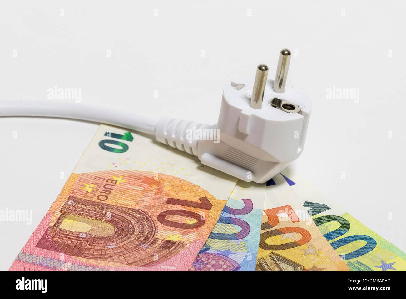 Money notes, symbol image, energy costs, electricity costs, plug, power cable Stock Photo