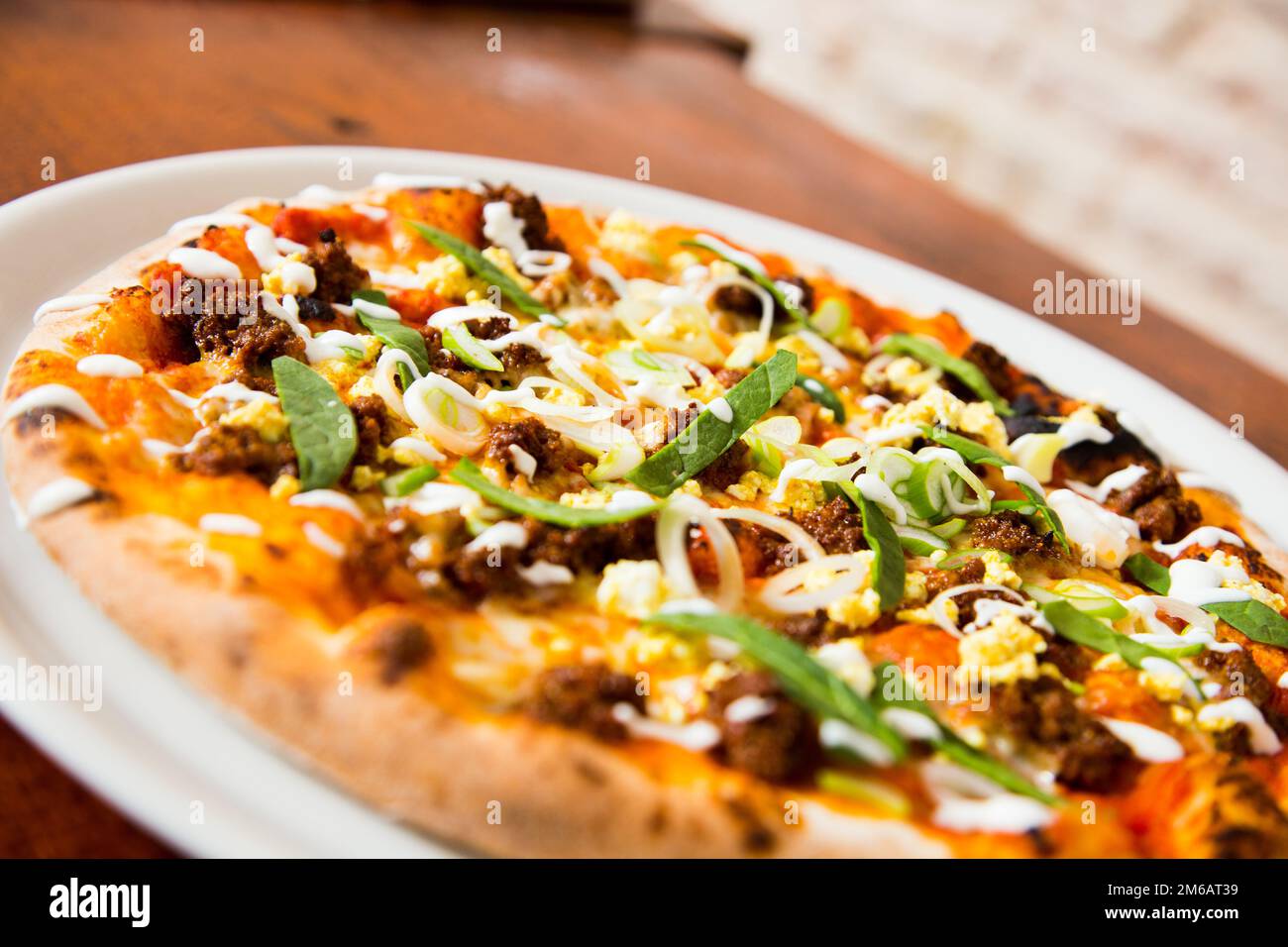 Pizza with meat and curry. Neapolitan pizza made with curryspiced beef