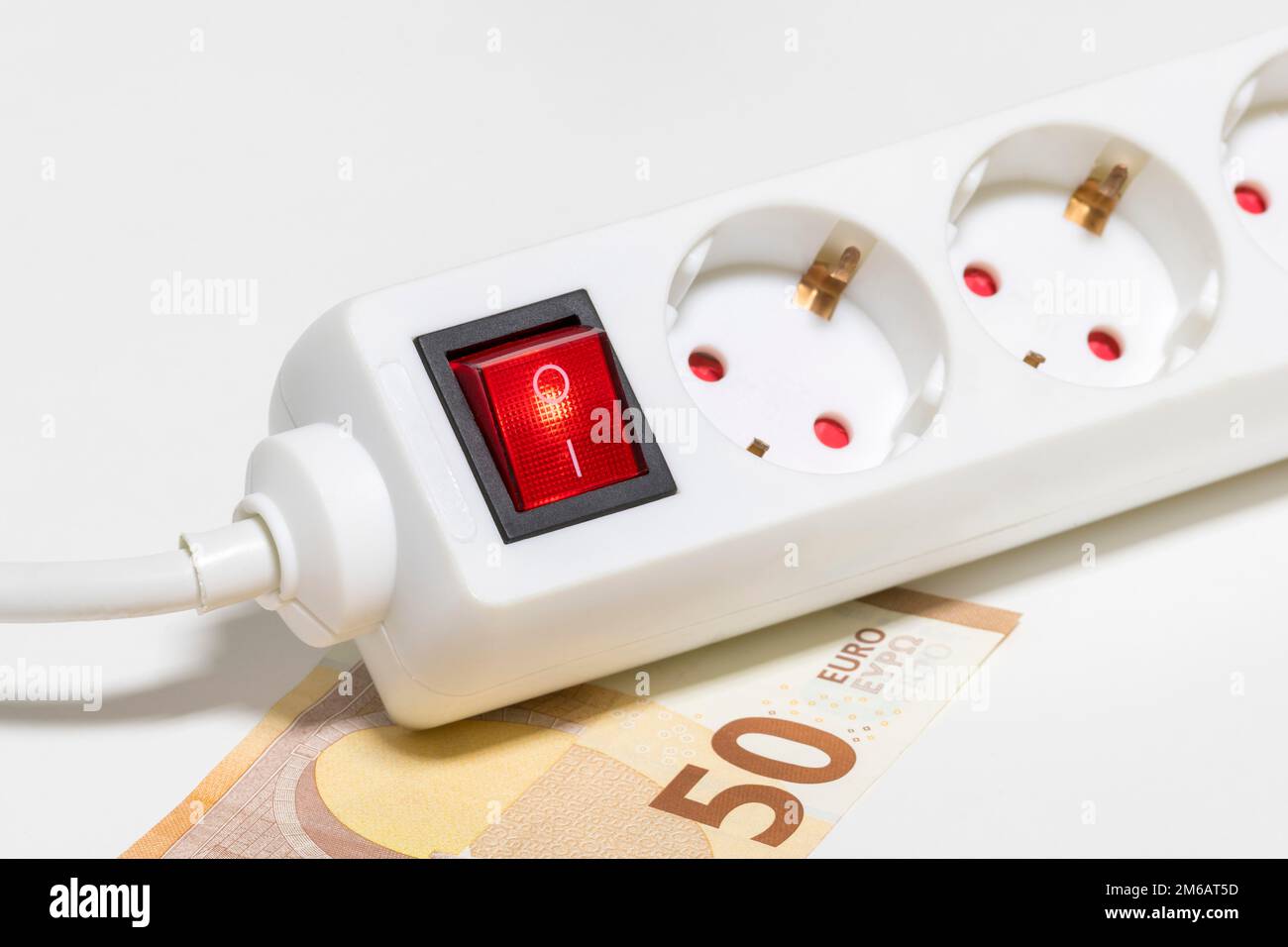 Switchable power outlet strip strip, euro banknote, symbol energy costs, electricity costs, energy saving Stock Photo
