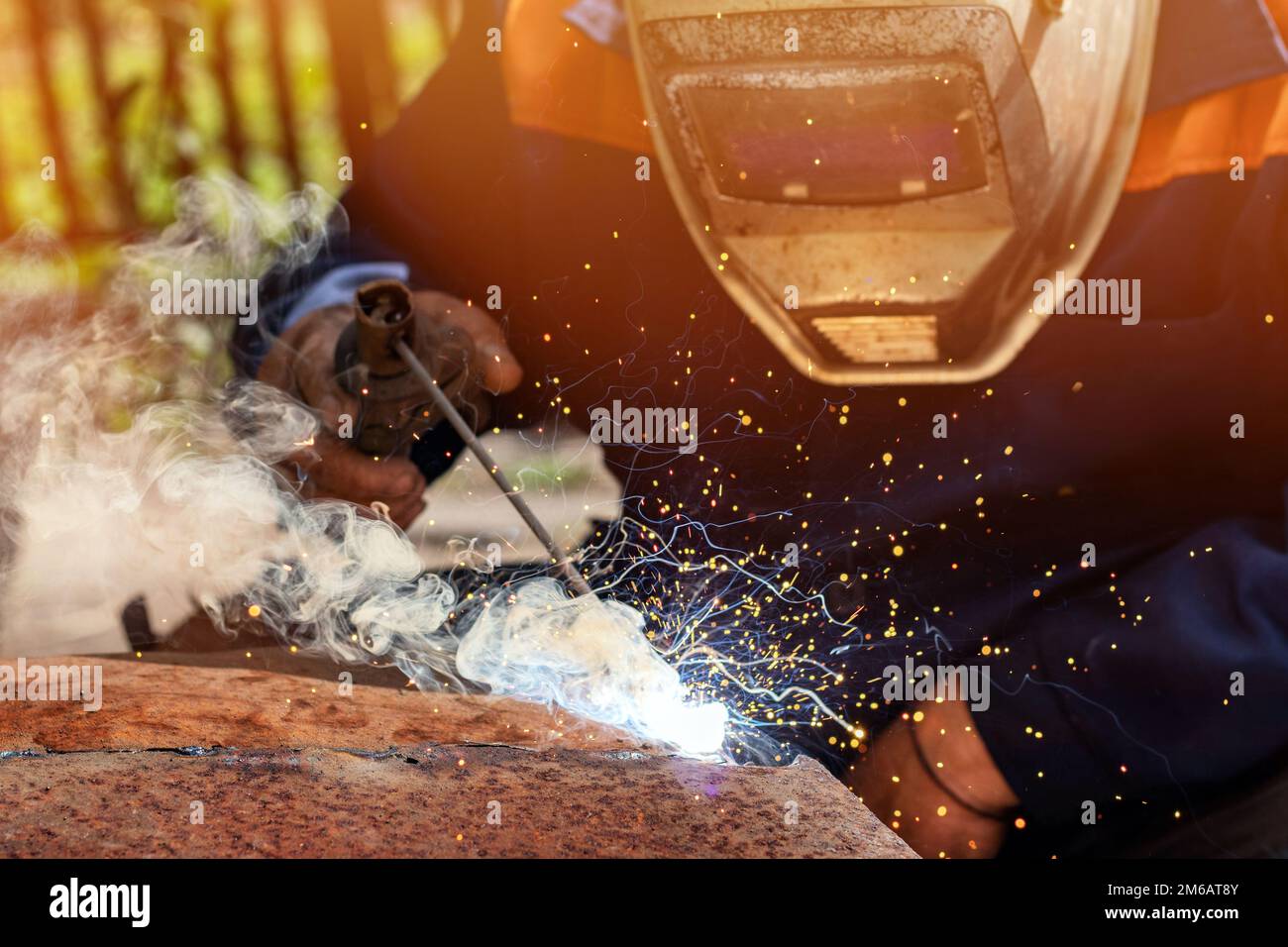 Welder erecting technical steel. Industrial steel welder in factory ...