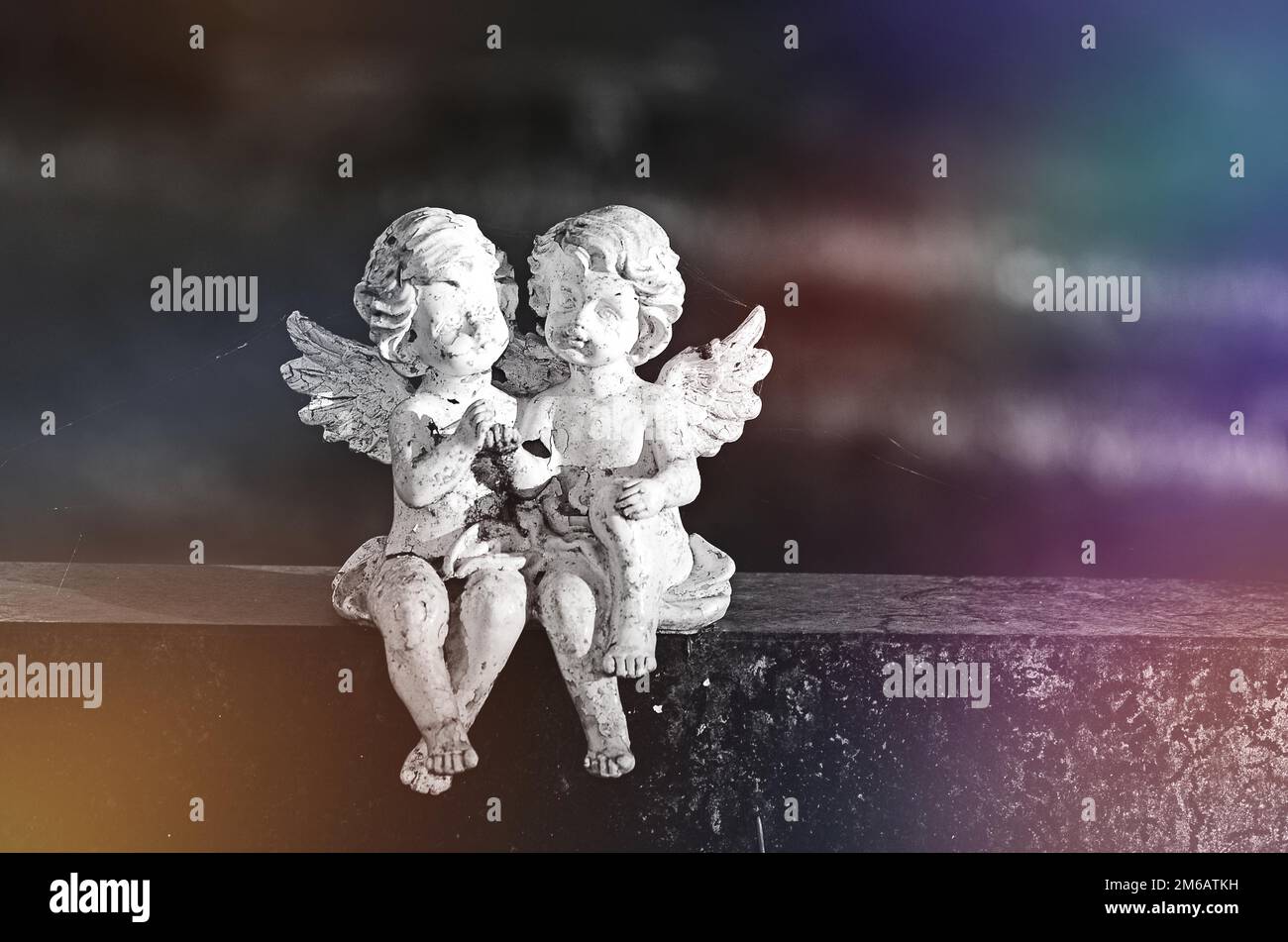 Two angel figures sitting on a gravestone, Germany Stock Photo - Alamy