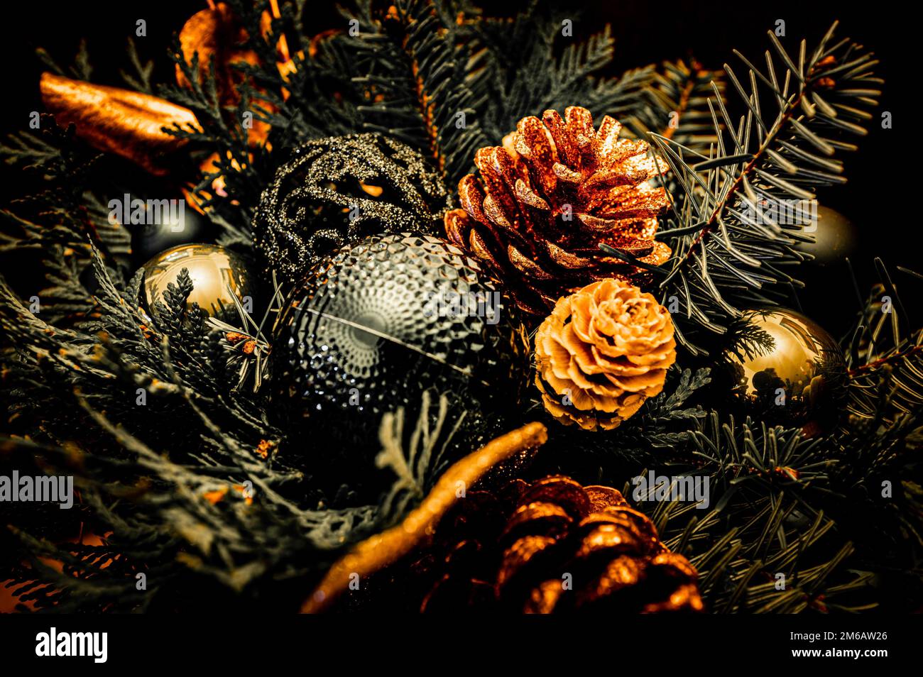 Christmas bouquet of spruce (Picea), pine (Pinus) and Nordmann fir (Abies nordmanniana) branches with golden pine cones (pinea), green and golden Stock Photo
