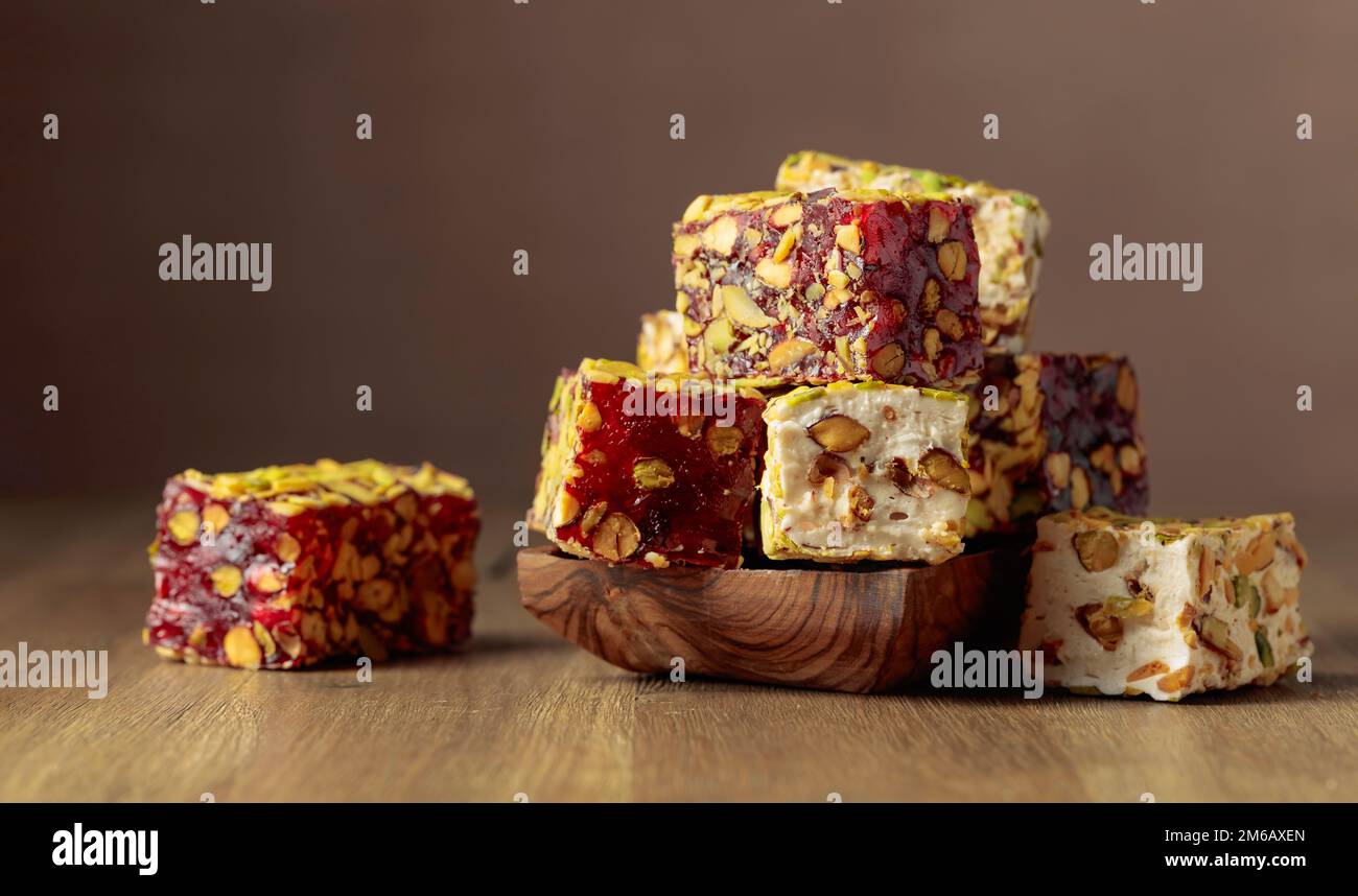 Traditional Turkish delight in a small dish on a wooden table. Stock Photo