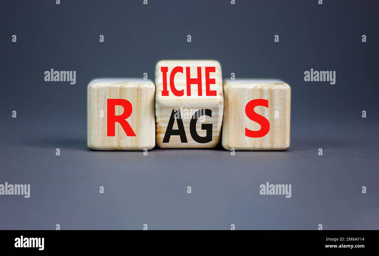 Rags or riches symbol. Concept word Rags Riches on wooden cubes ...