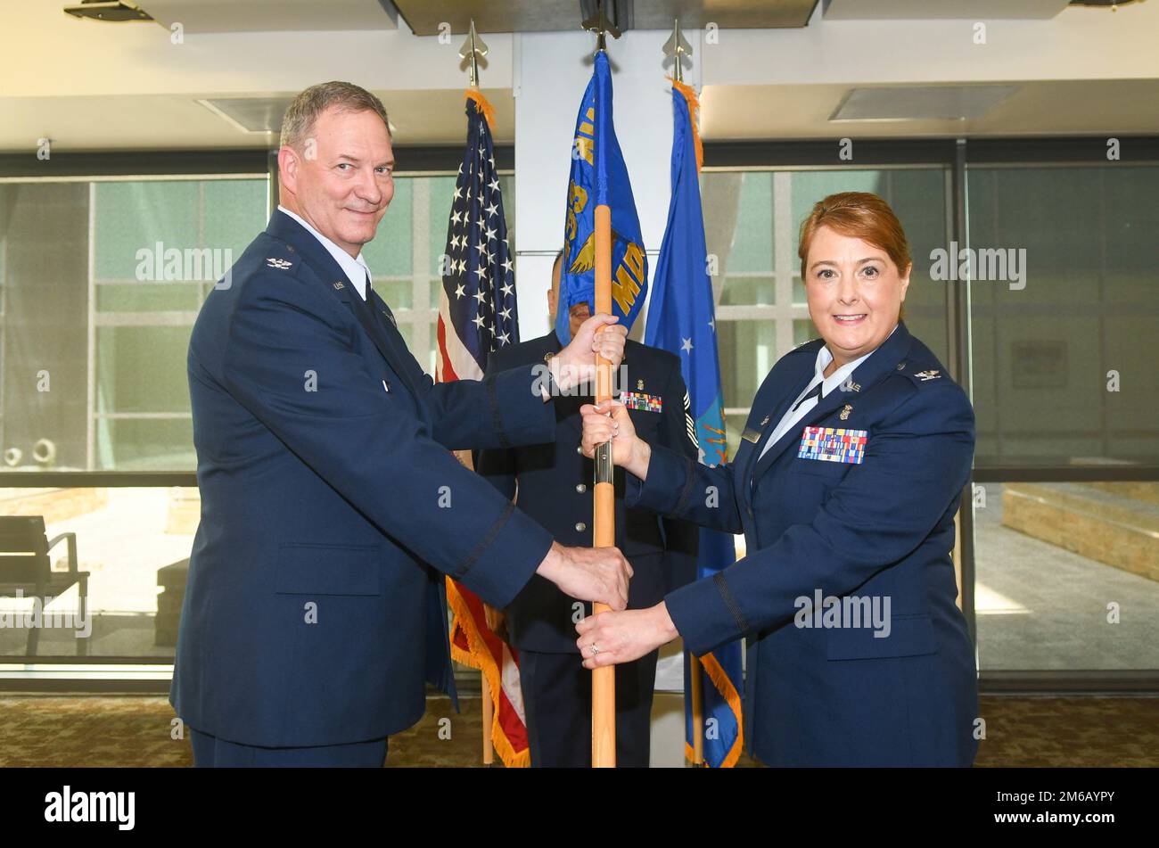 Col. Terry McClain, 433rd Airlift Wing commander, presents the guidon
