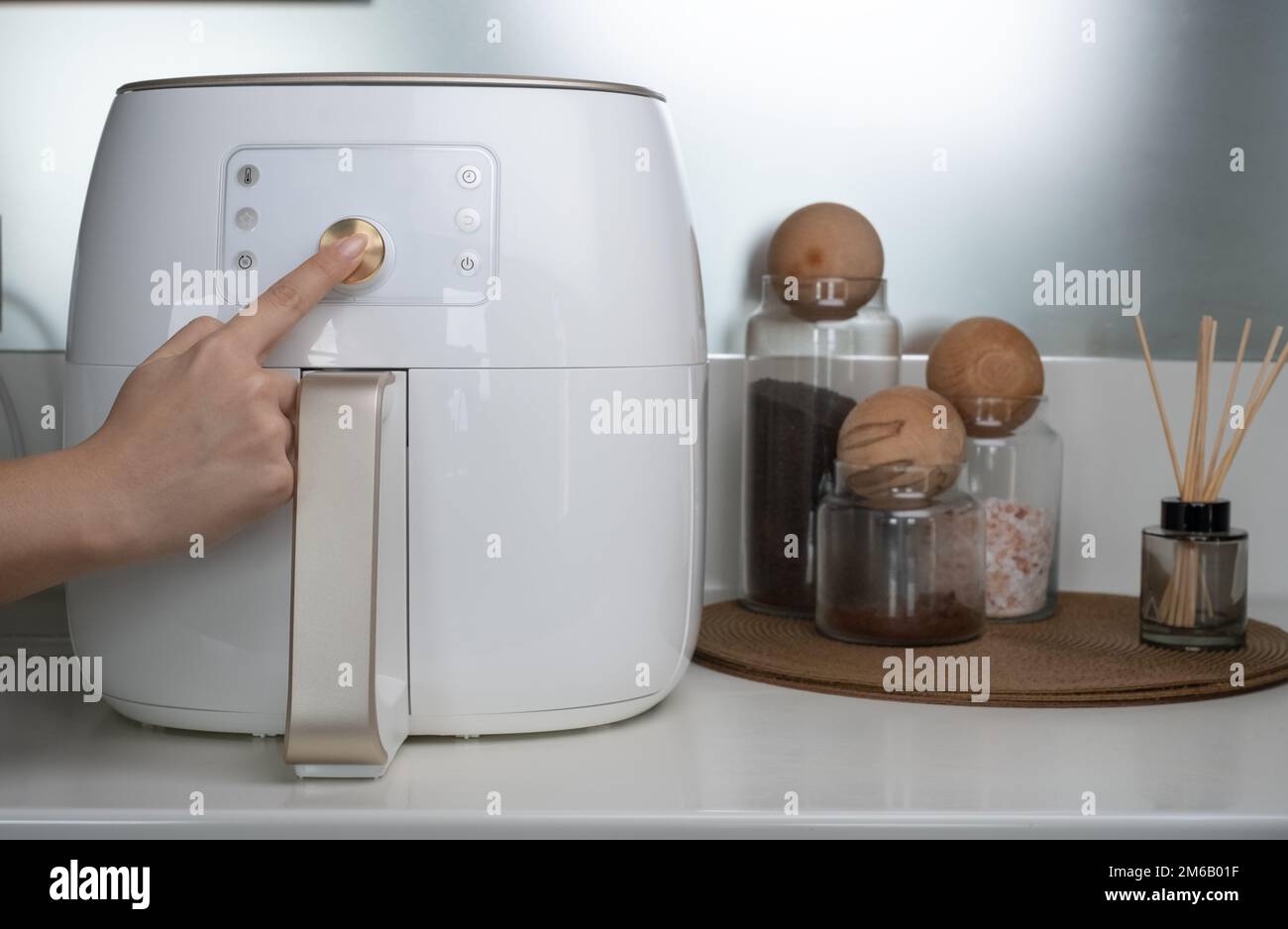 https://c8.alamy.com/comp/2M6B01F/deep-fryer-machine-in-modern-home-kitchen-the-hand-that-adjusts-the-fryer-machine-2M6B01F.jpg