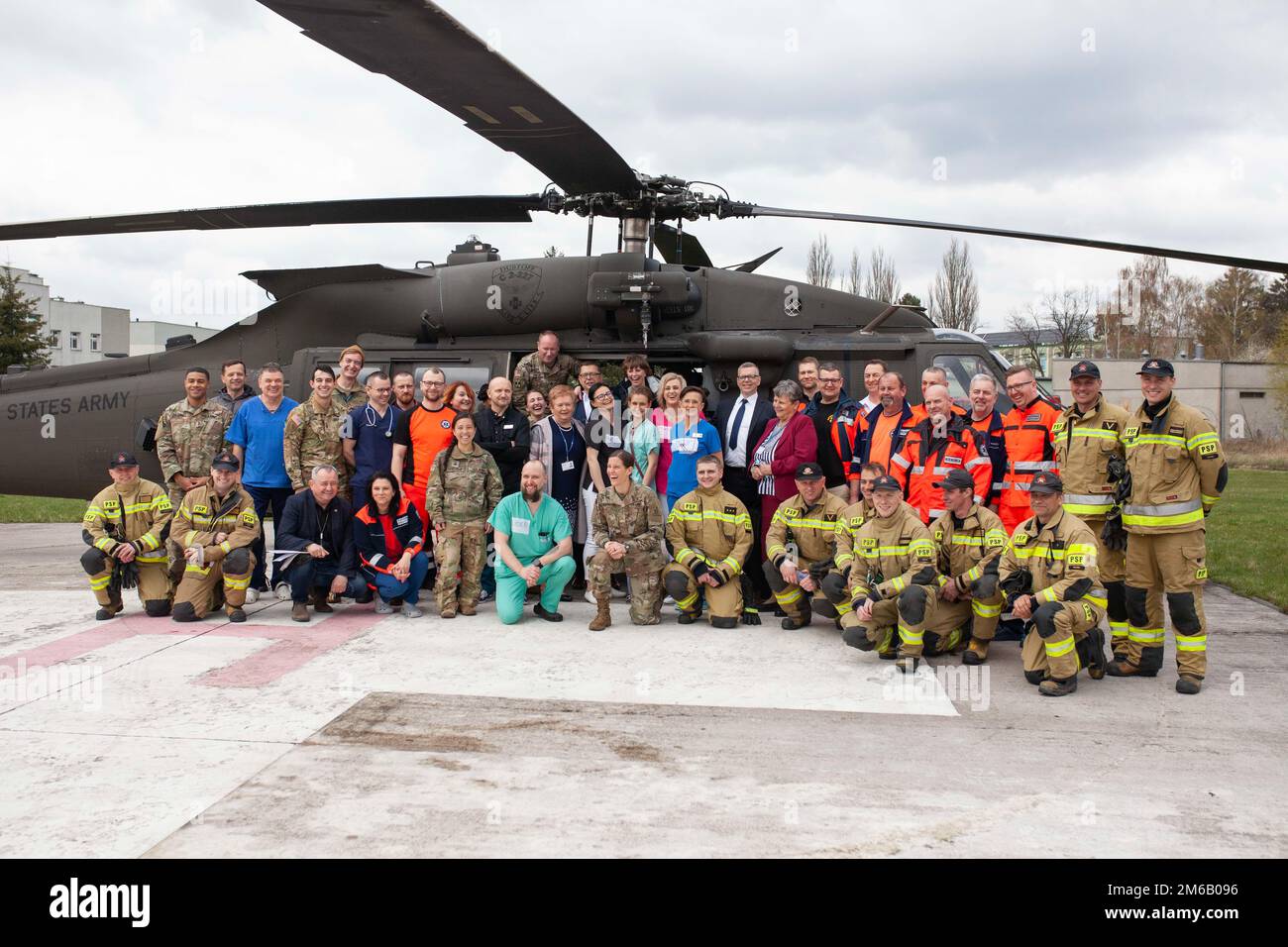 Group photo of polish medical staff and firefighters from Konin, TriCare reps posing  together in front of a H-60 Black Hawk helicopter with U.S Army soldiers, medics and pilots stationed at Powidz Air Base. Stock Photo
