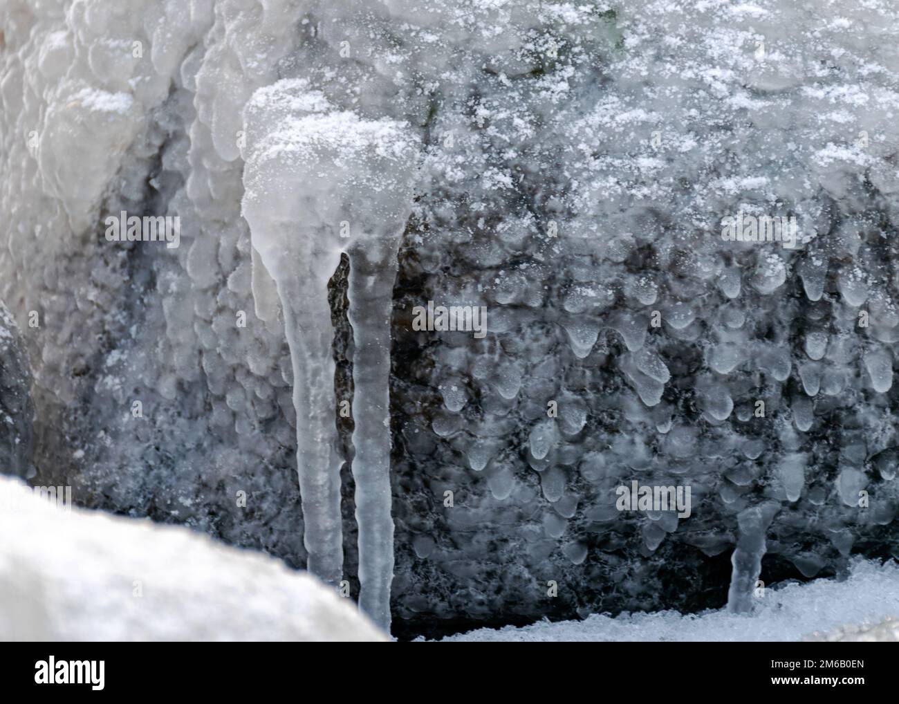 different ice formations on rocks on the seashore, ice texture, wind ...