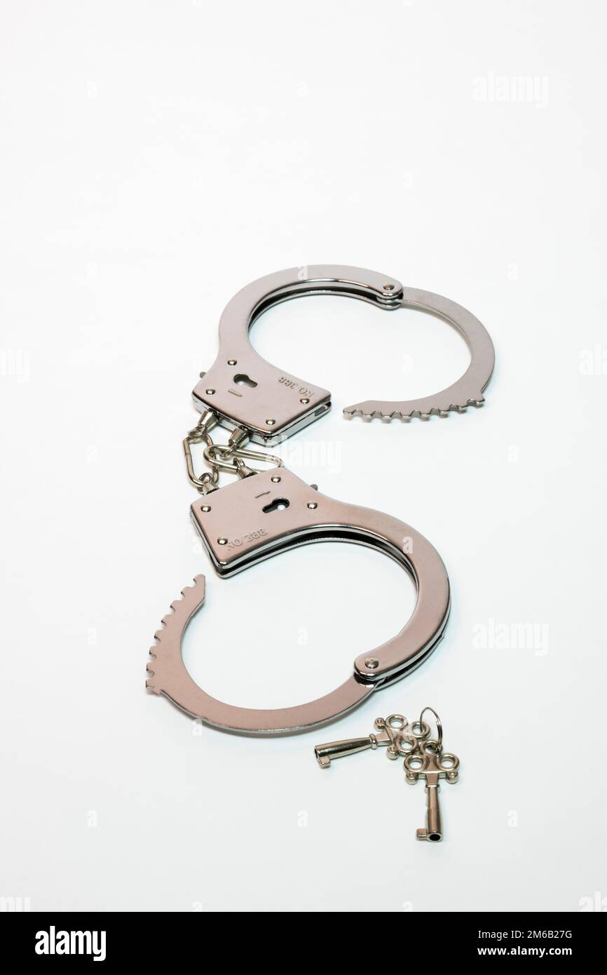 Handcuffs with key Stock Photo Alamy