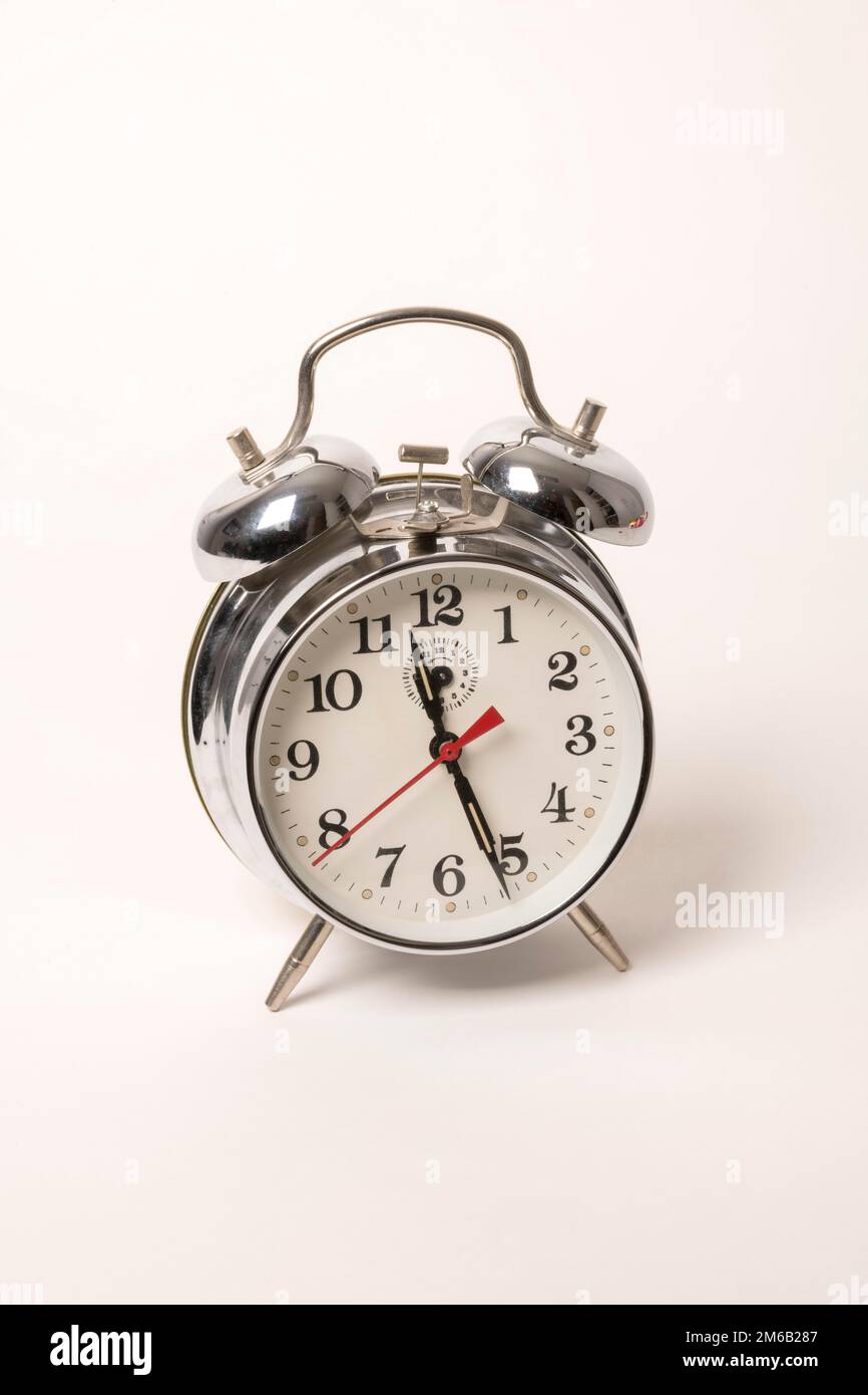 Metal alarm clock with mechanical clockwork and bell mechanism Stock
