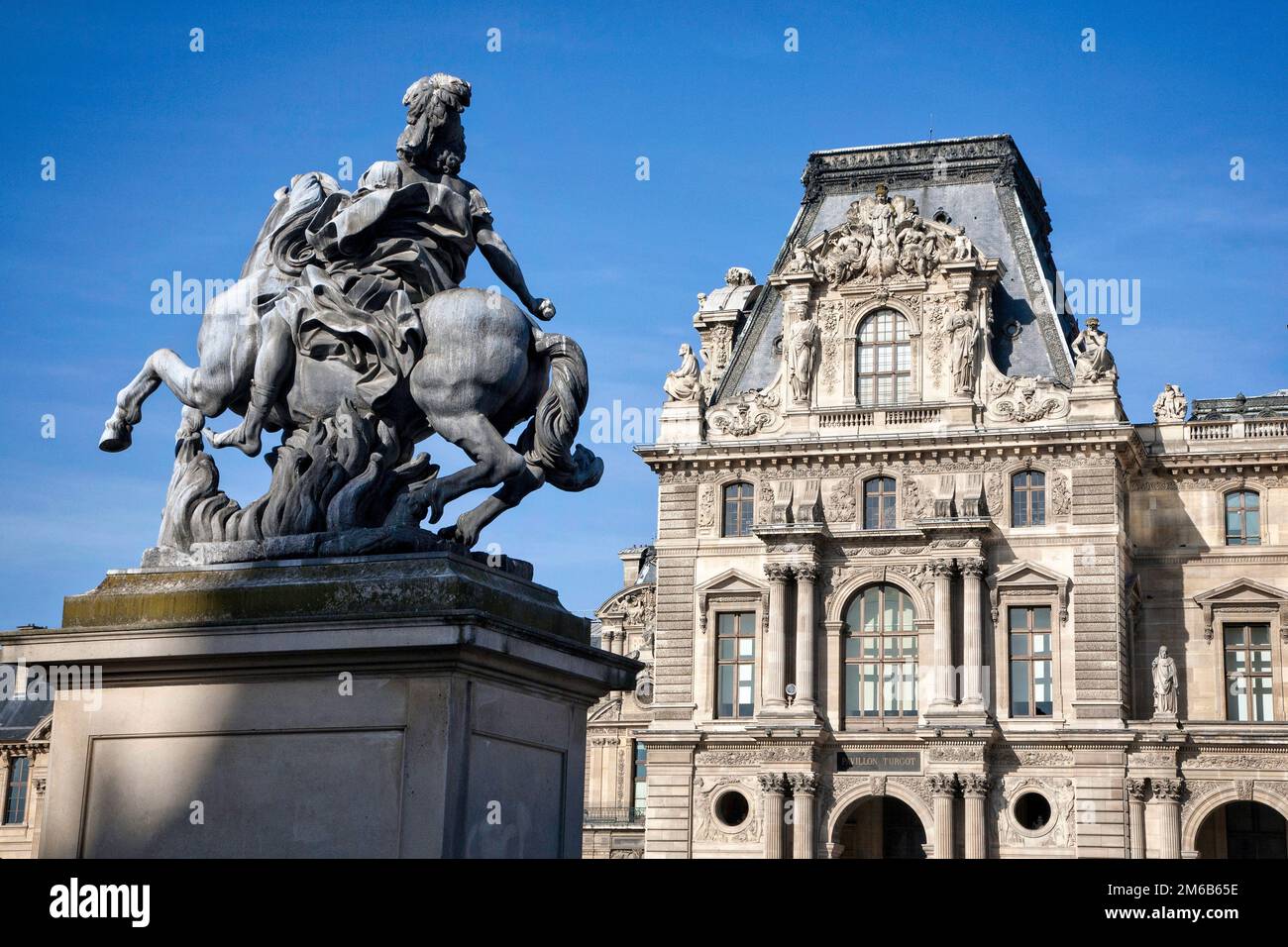 The exterior facade and statue at the world famous Louvre museum in  Paris, France. Stock Photo