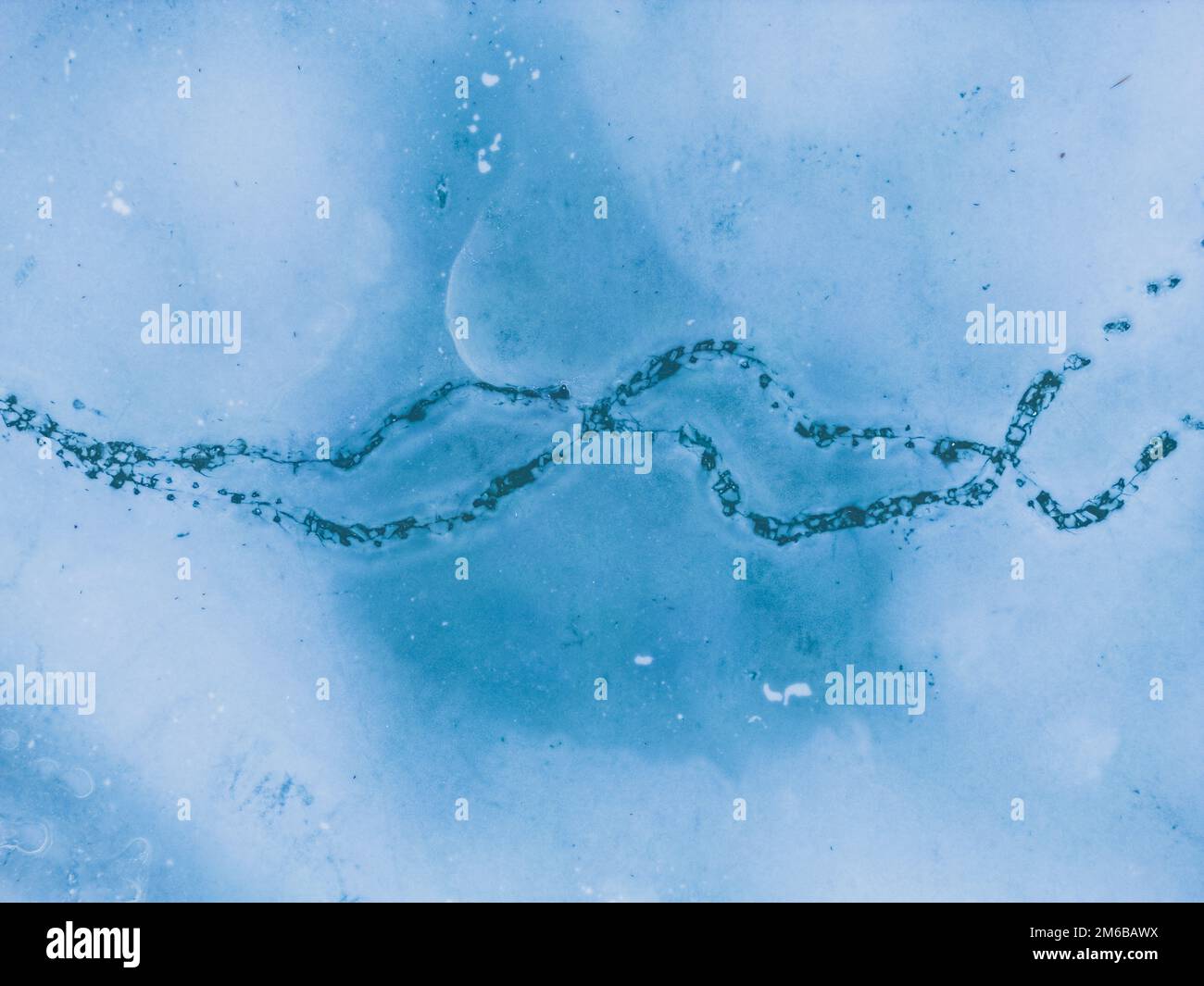 Panoramic aerial view of a frozen lake with animal footprints. Animal tracks on the frozen surface of the lake Stock Photo