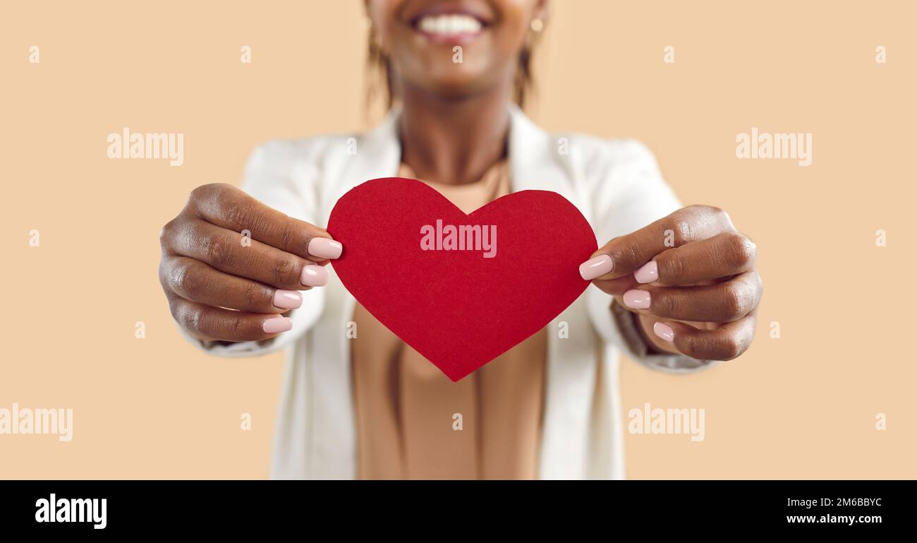 Crop of black woman hold in hands red paper heart Stock Photo