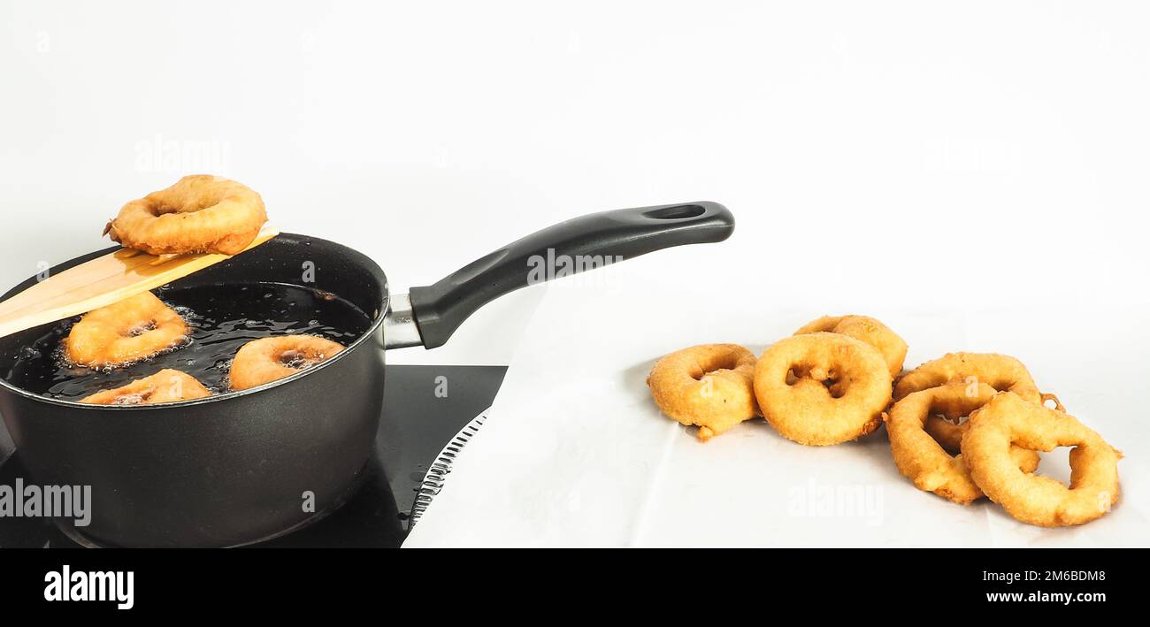 Fresh made doughnuts from boiling hot oil onto baking paper Stock Photo