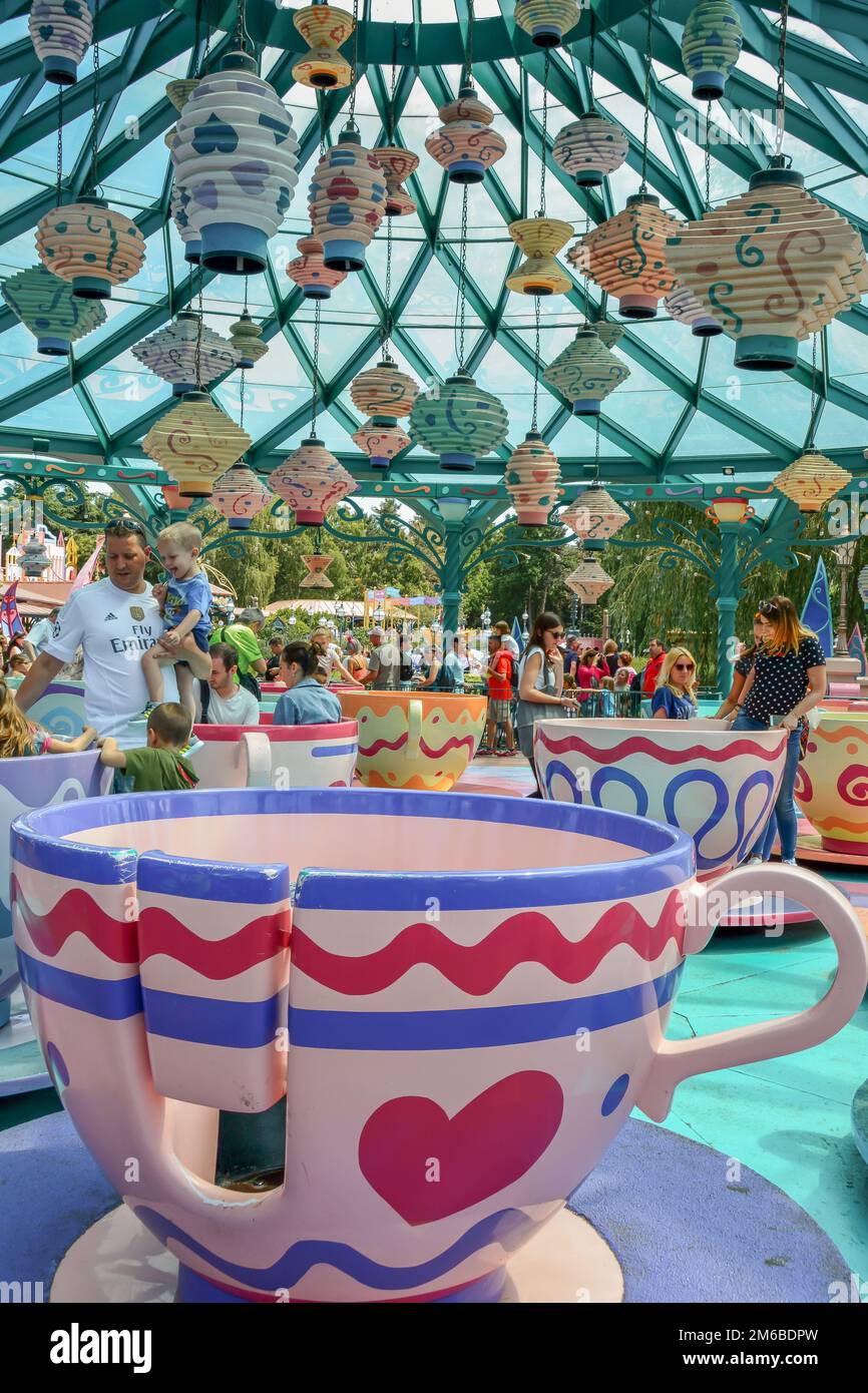 A beautiful shot of people enjoying the Mad Hatter's Tea Cups' carousel