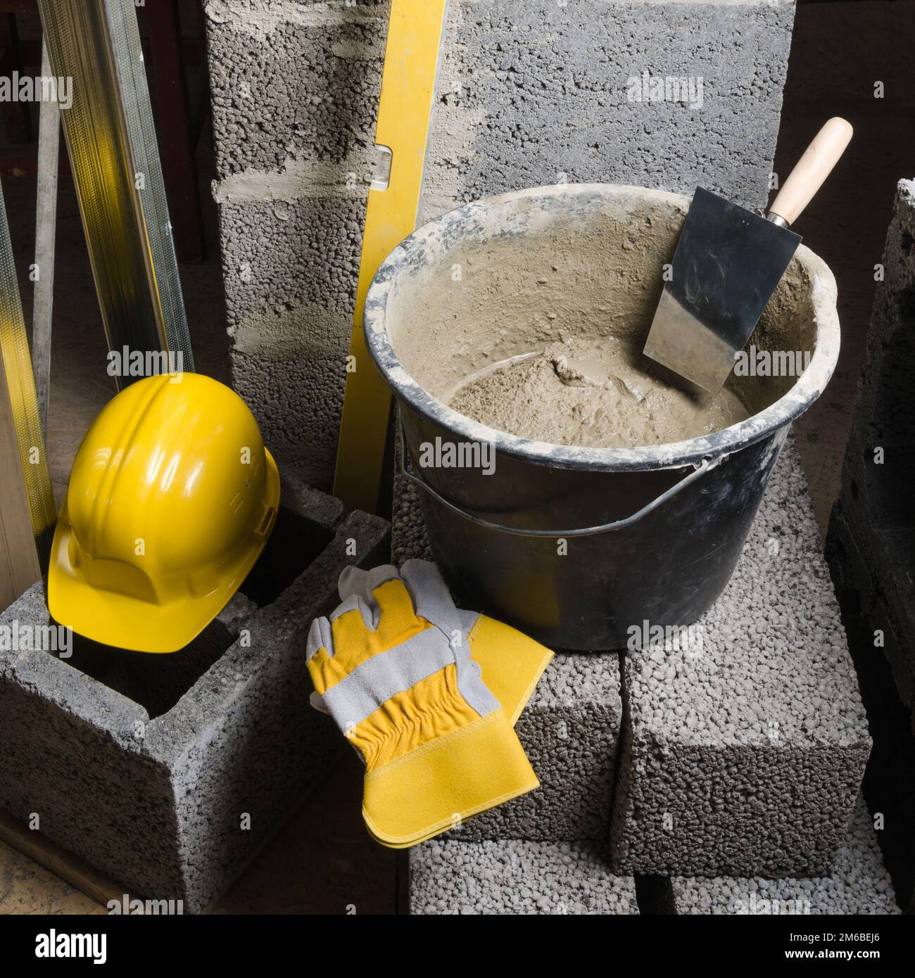 Tools for bricklayer bucket with a solution and a trowel, closeup
