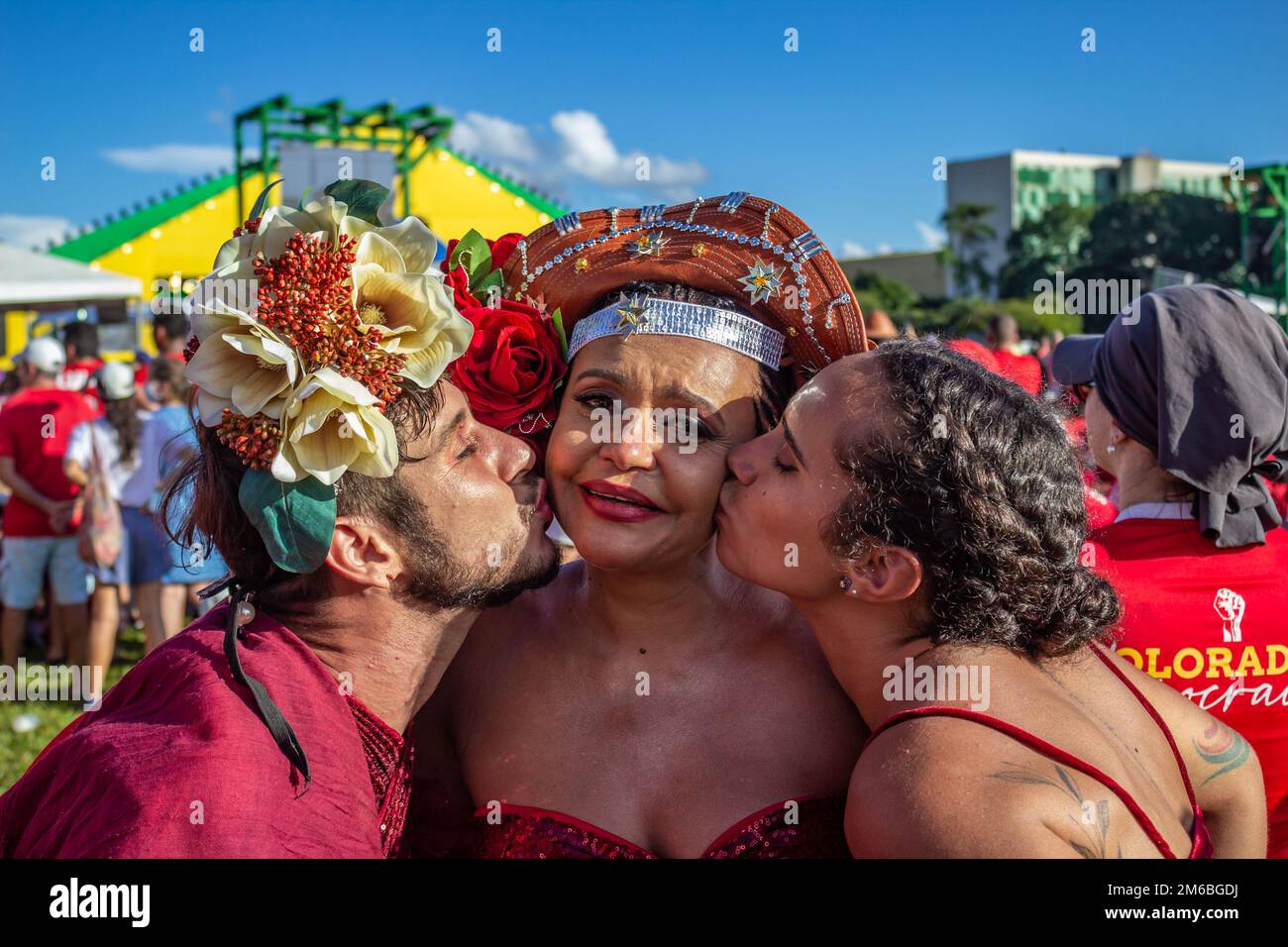 Brasília, DF, Brazil – January 01, 2023: Three people embraced and moved during the speech of the new president of Brazil. Stock Photo