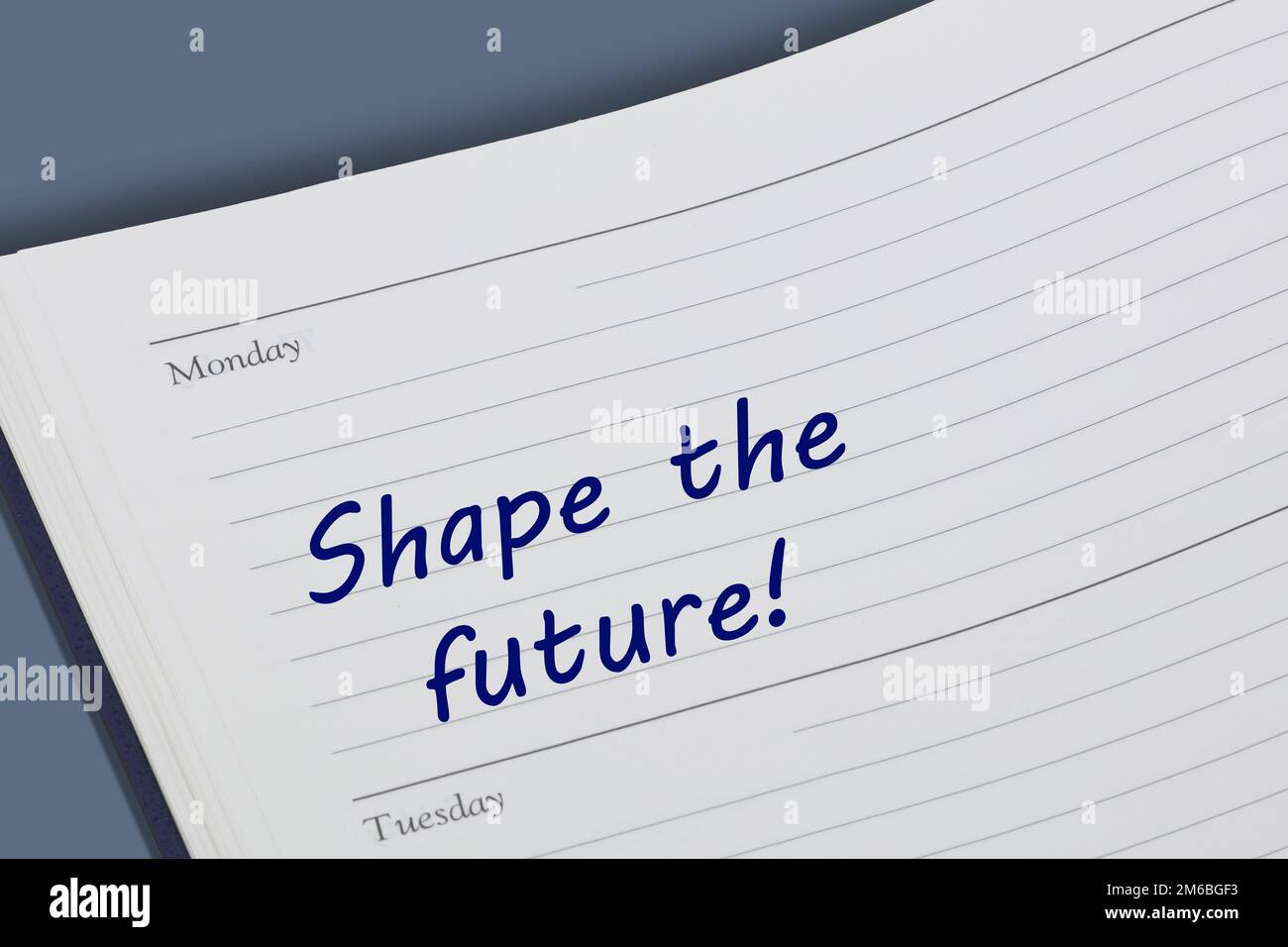 Shape the future reminder message open on desk Stock Photo