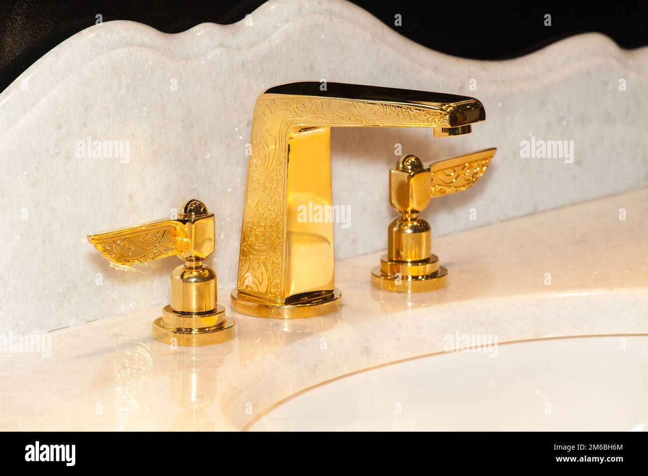 Gold faucet in bathroom Stock Photo Alamy