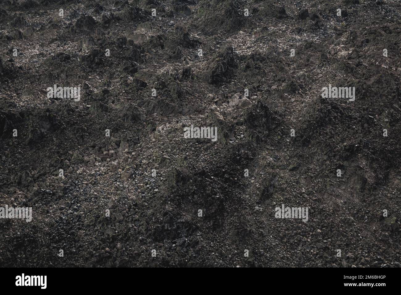 Black volcanic lava flow basalt fields close up macro background ...