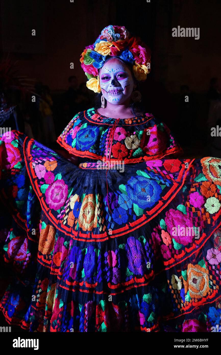A women wearing traditional embroidered Mexican folk dress and floral headdress for the Catrina Parade, part of Day of the Dead, Merida, Mexico Stock Photo