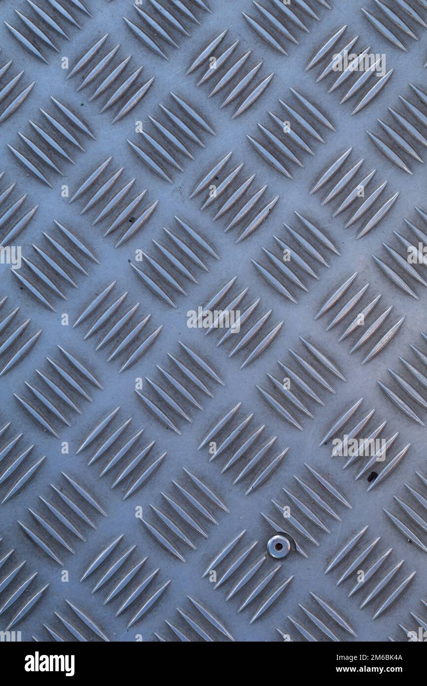 Non-slip industrial steel metal flooring, shot from above, flat lighting. Stock Photo